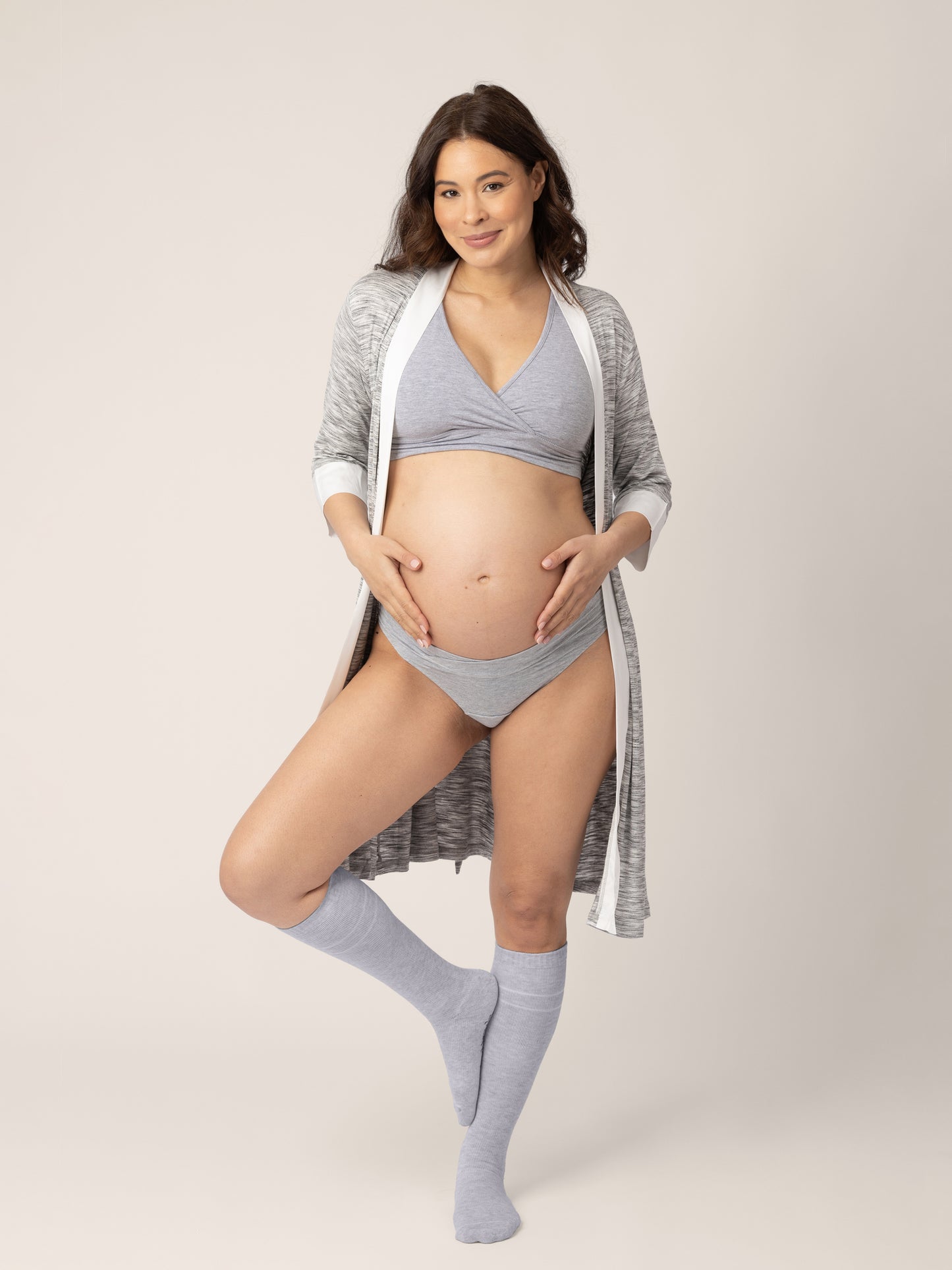 Premium Photo  A pregnant woman in an underwear with hands on her belly