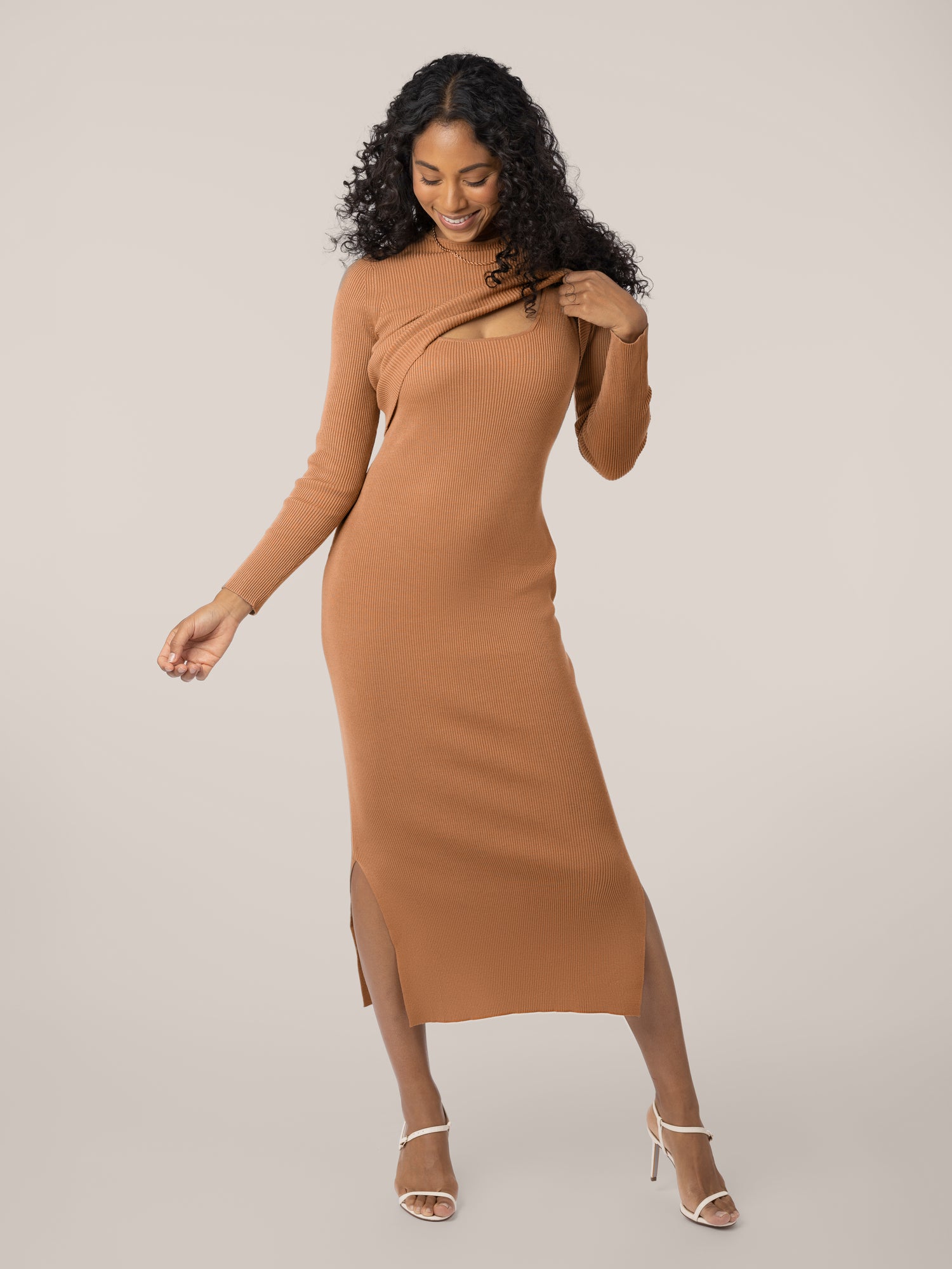 Front view of model wearing the 2-in-1 Maternity & Nursing Midi Dress in Camel, lifting up outer long-sleeve crop top layer @model_info:Anastacia is 5'8" and wearing a Small.