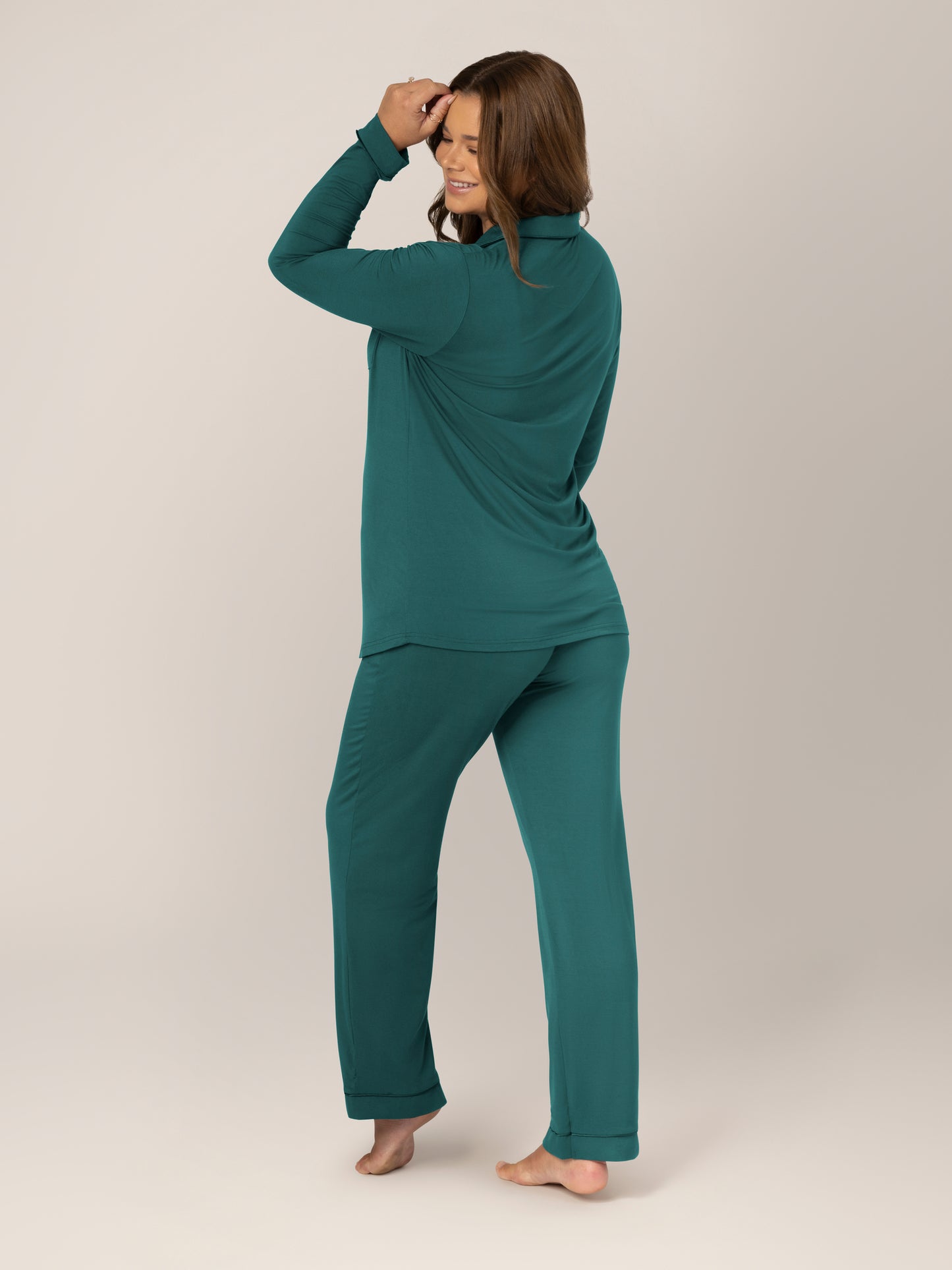 3/4 back view of pregnant wearing the Clea Bamboo Long Sleeve Pajama Set in Evergreen 