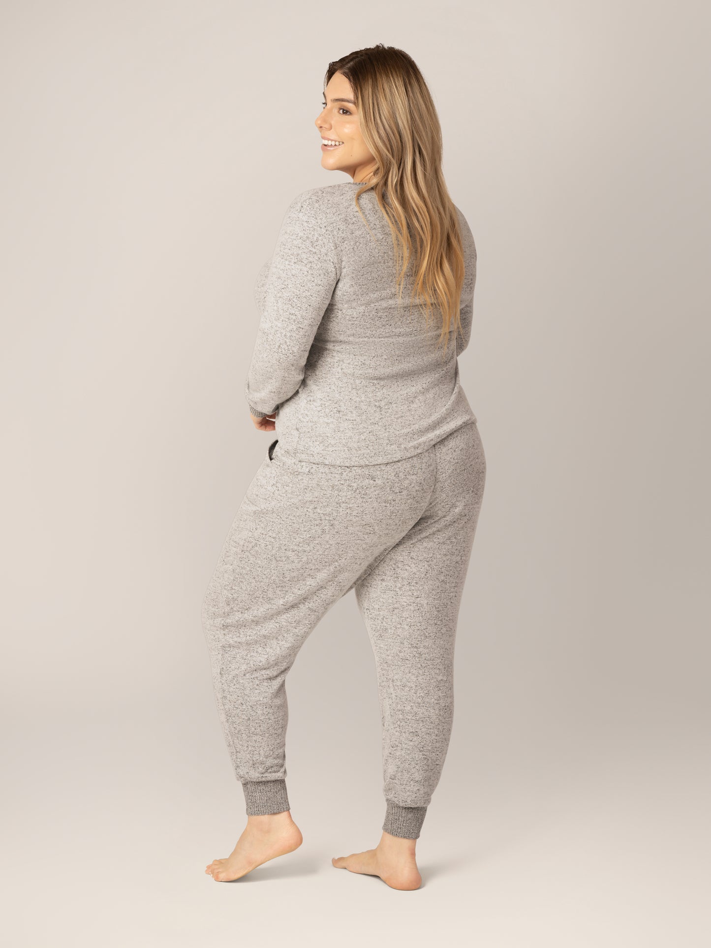 3/4 back view of model wearing the Zoe Nursing Pajama & Lounge Set in Grey Heather. 