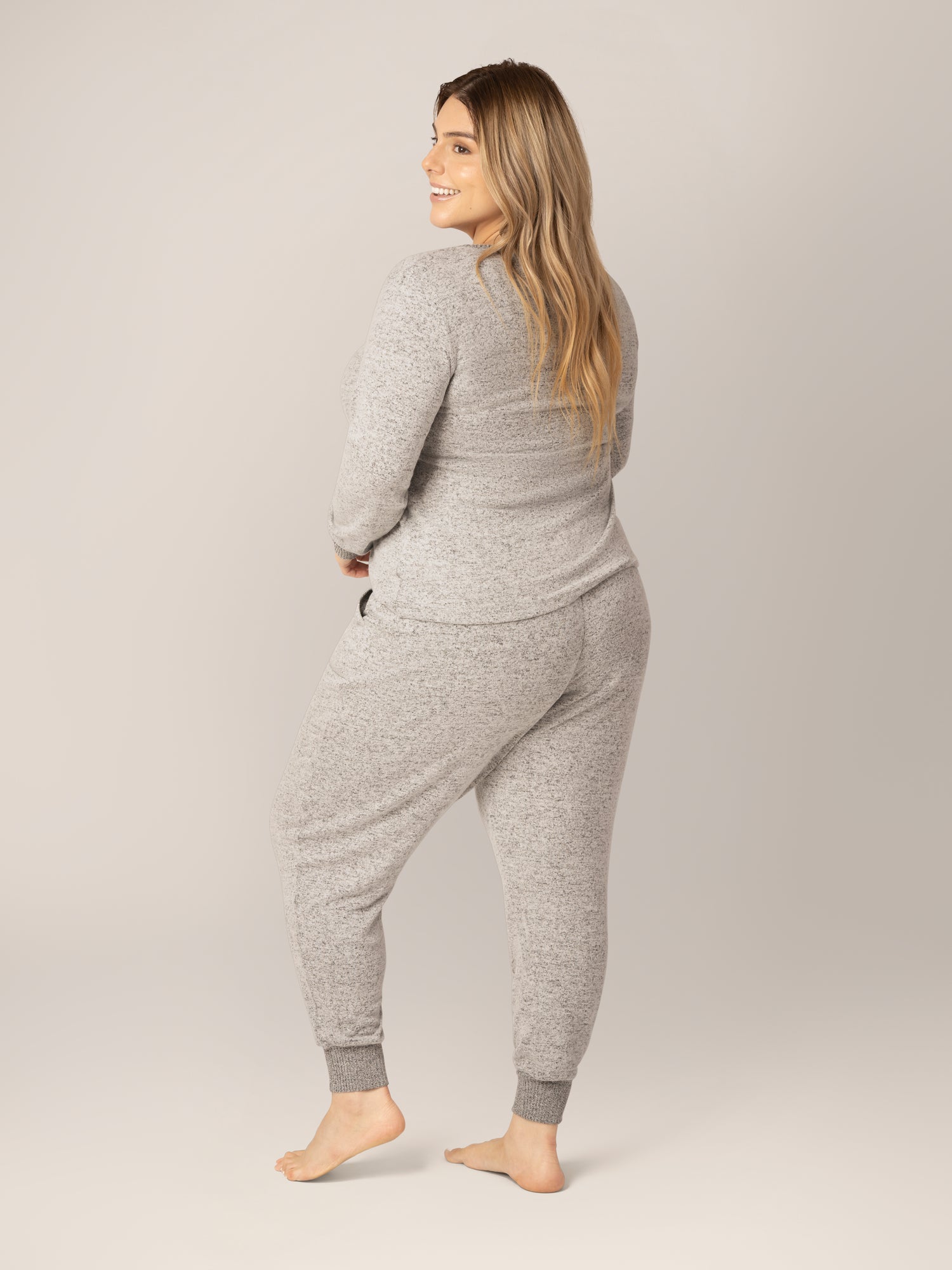 3/4 back view of model wearing the Zoe Nursing Pajama & Lounge Set in Grey Heather. 