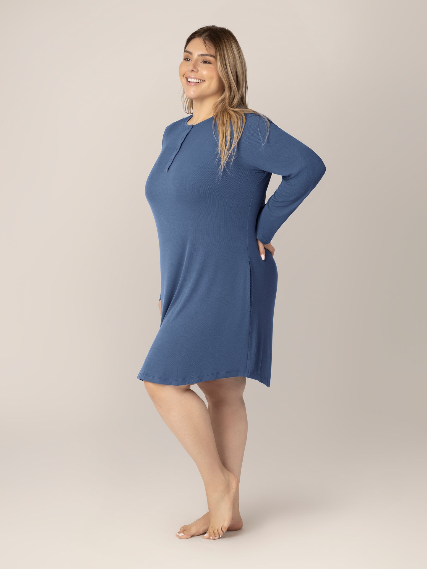 3/4 side view of model wearing the Riley Ribbed Bamboo Maternity & Nursing Nightgown in Slate Blue. 