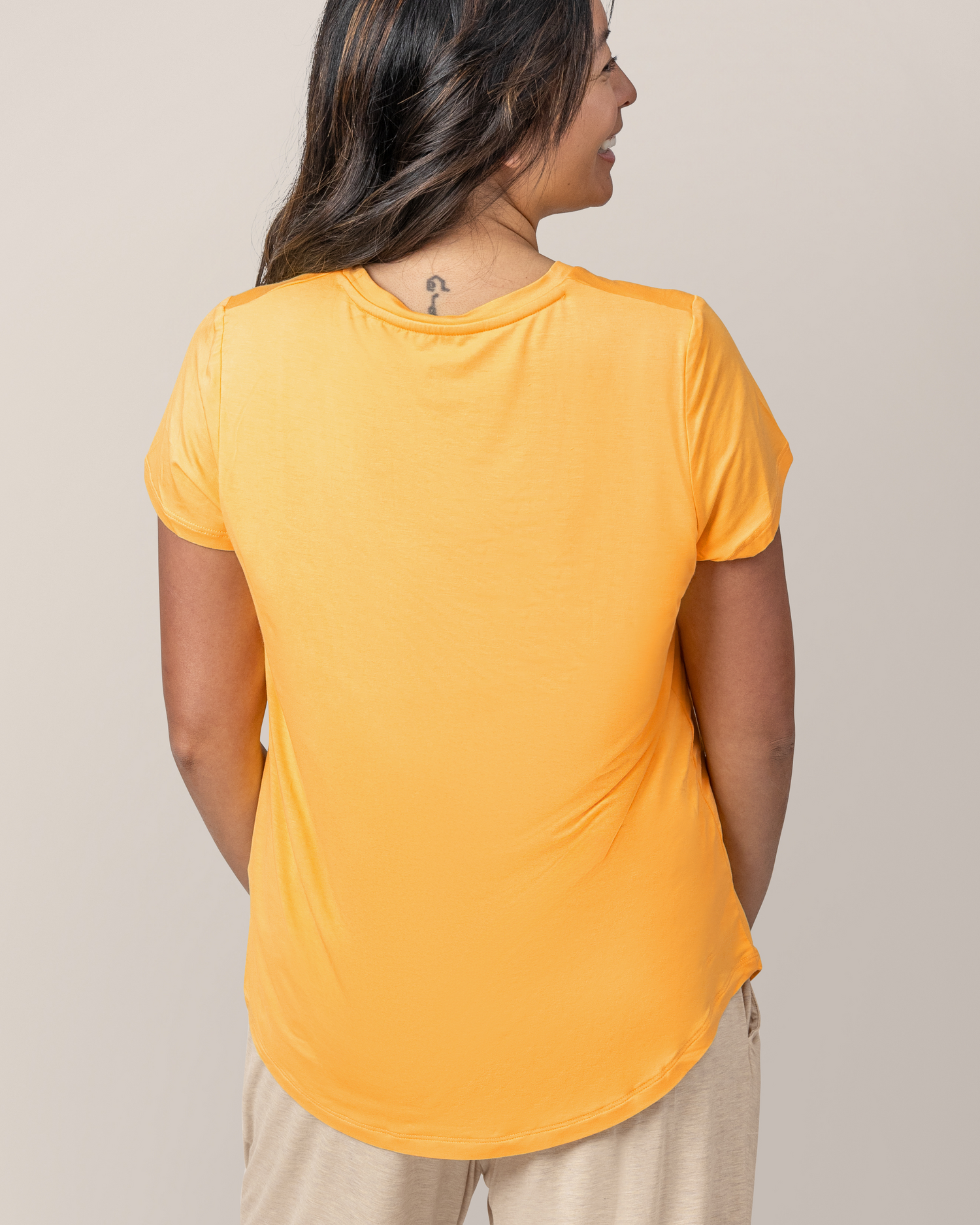 Back view of model wearing Everyday Maternity & Nursing T-shirt in Marigold