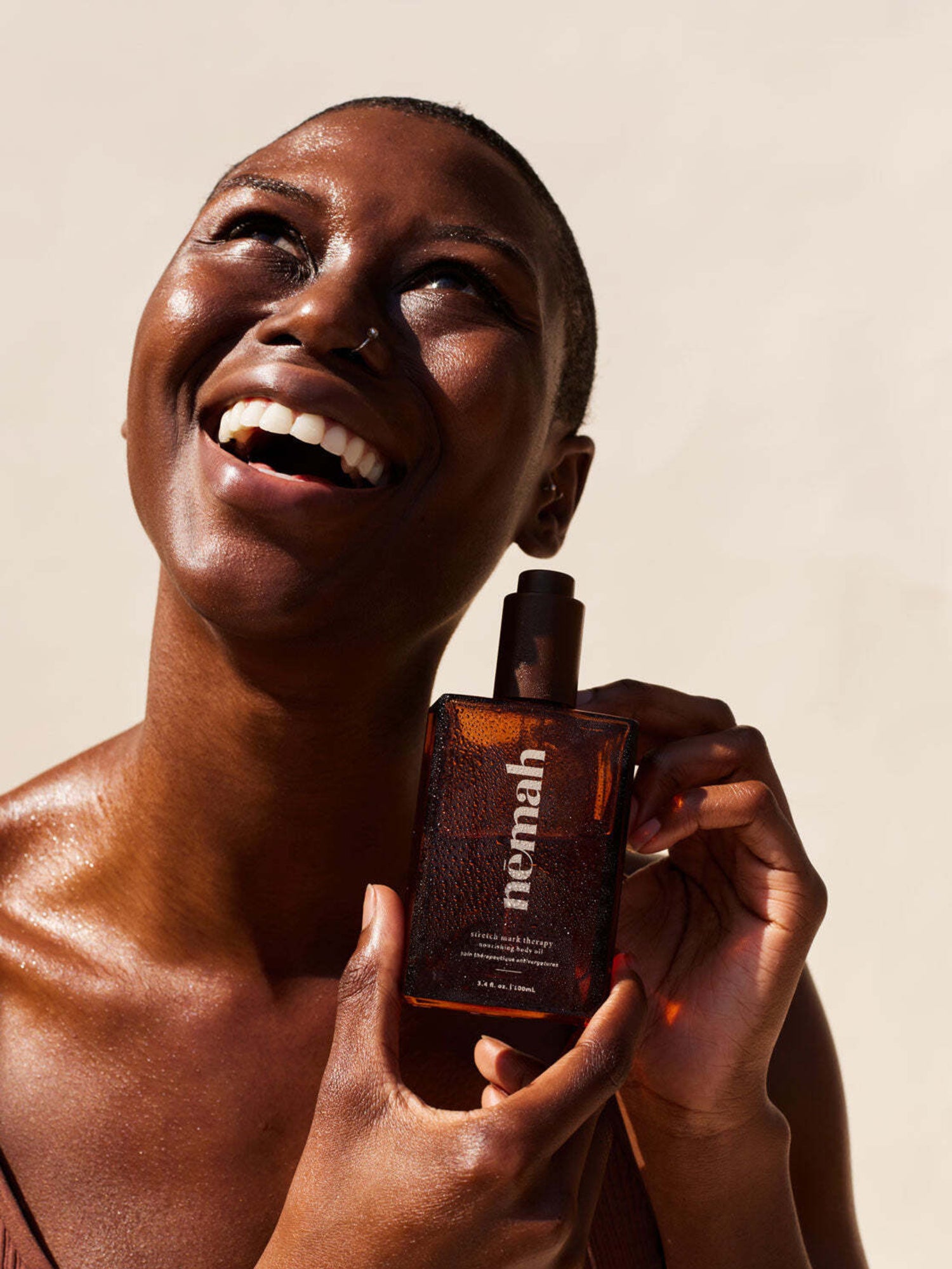 Model holding Nēmah - Nourishing Belly Oil | Kindred Bravely