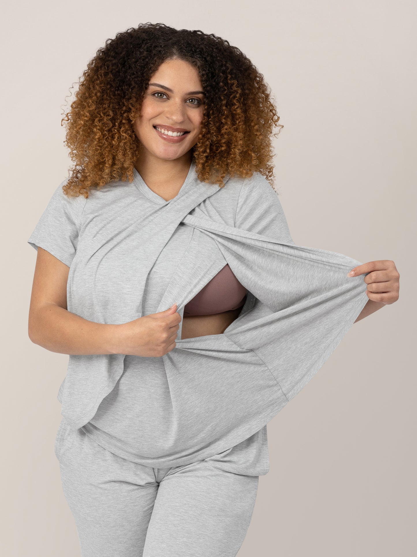 Model wearing the Tulip Hem Maternity and Nursing Pajama Set and opening the front to show nursing access.