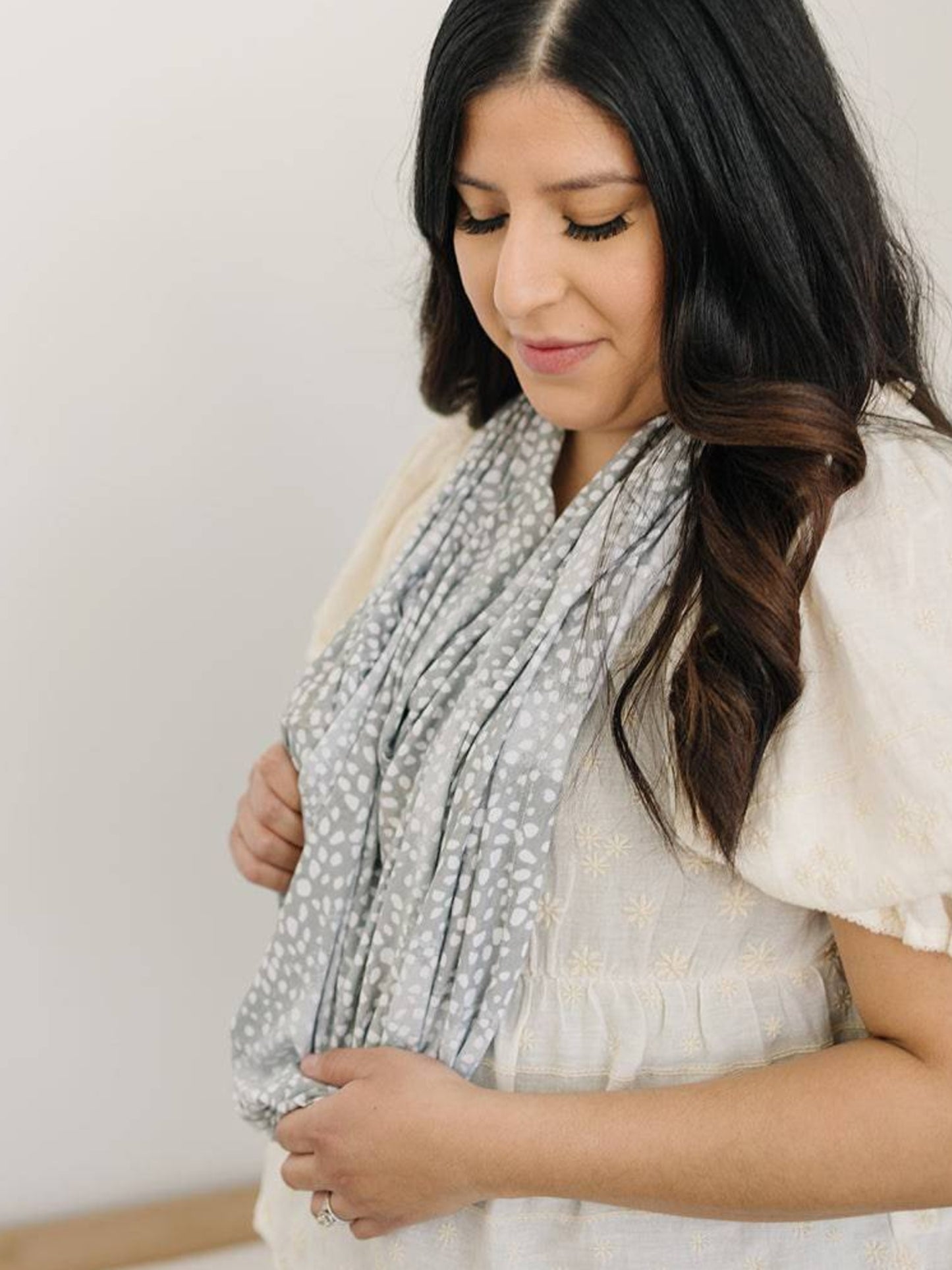 Model wearing the Bebe au Lait - 5-in-1 Multi-Use Nursing Cover in Animal Ombre as an infinity scarf