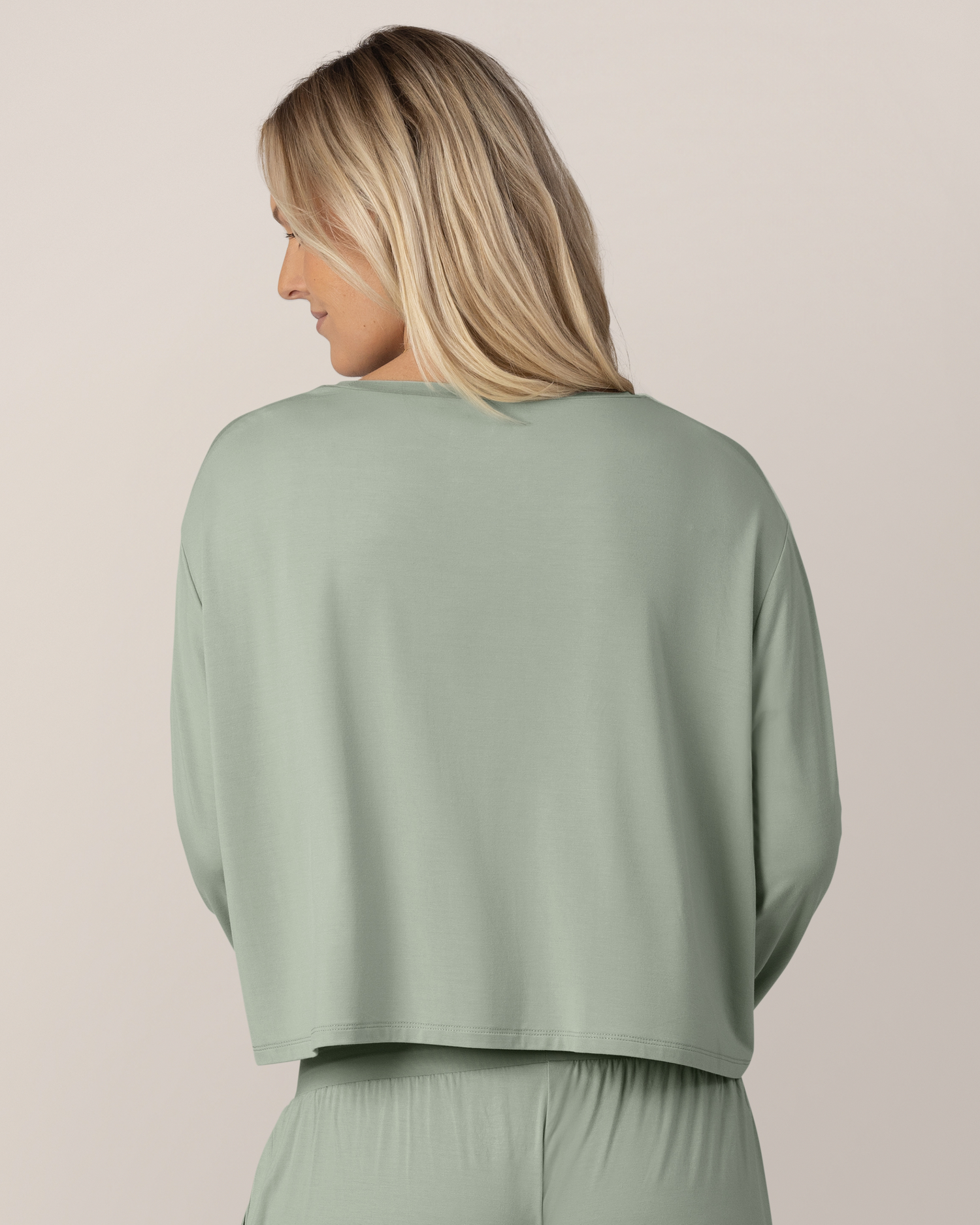 Back view of model wearing the Aria Bamboo Casual Cropped Long Sleeve Top in Aqua Mist 