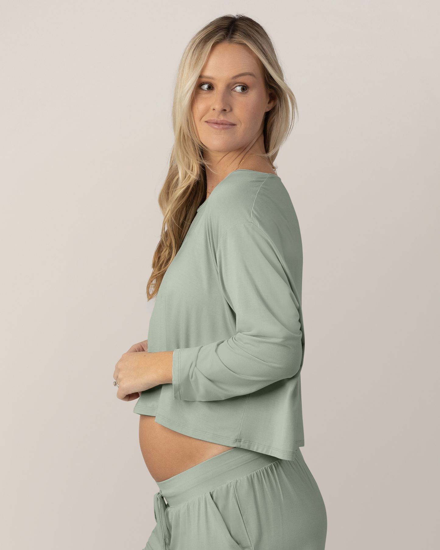 Side view of model wearing the Aria Bamboo Casual Cropped Long Sleeve Top in Aqua Mist @model_info:Maddy is wearing a Small.