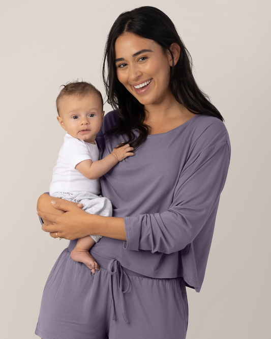 Model holding baby wearing the Aria Bamboo Casual Cropped Long Sleeve Top in Granite @model_info:Anamaria is wearing a Medium.