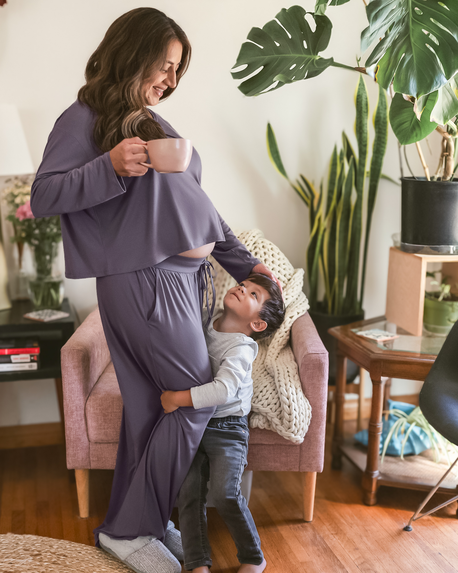 Pregnant model standing with child while wearing the Aria Bamboo Casual Cropped Long Sleeve Top in Granite paired with the matching Aria Bamboo Casual Lounge pant @model_info:Jacqueline is wearing a Medium.