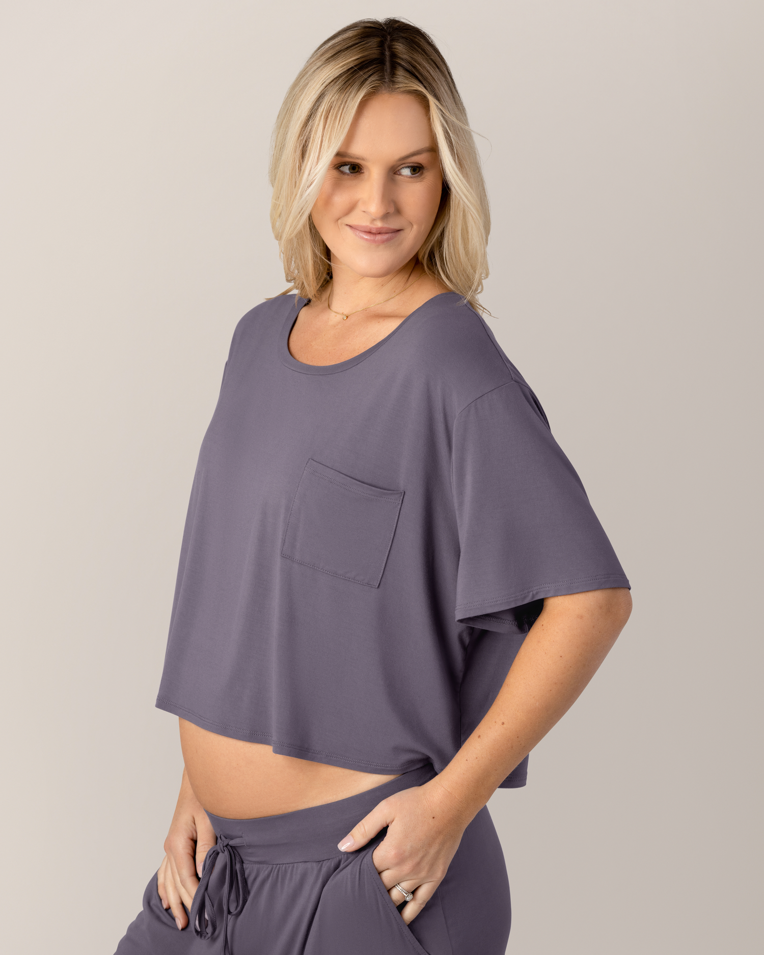 Side view of pregnant model wearing the Aria Bamboo Casual Cropped Short Sleeve Top in Granite