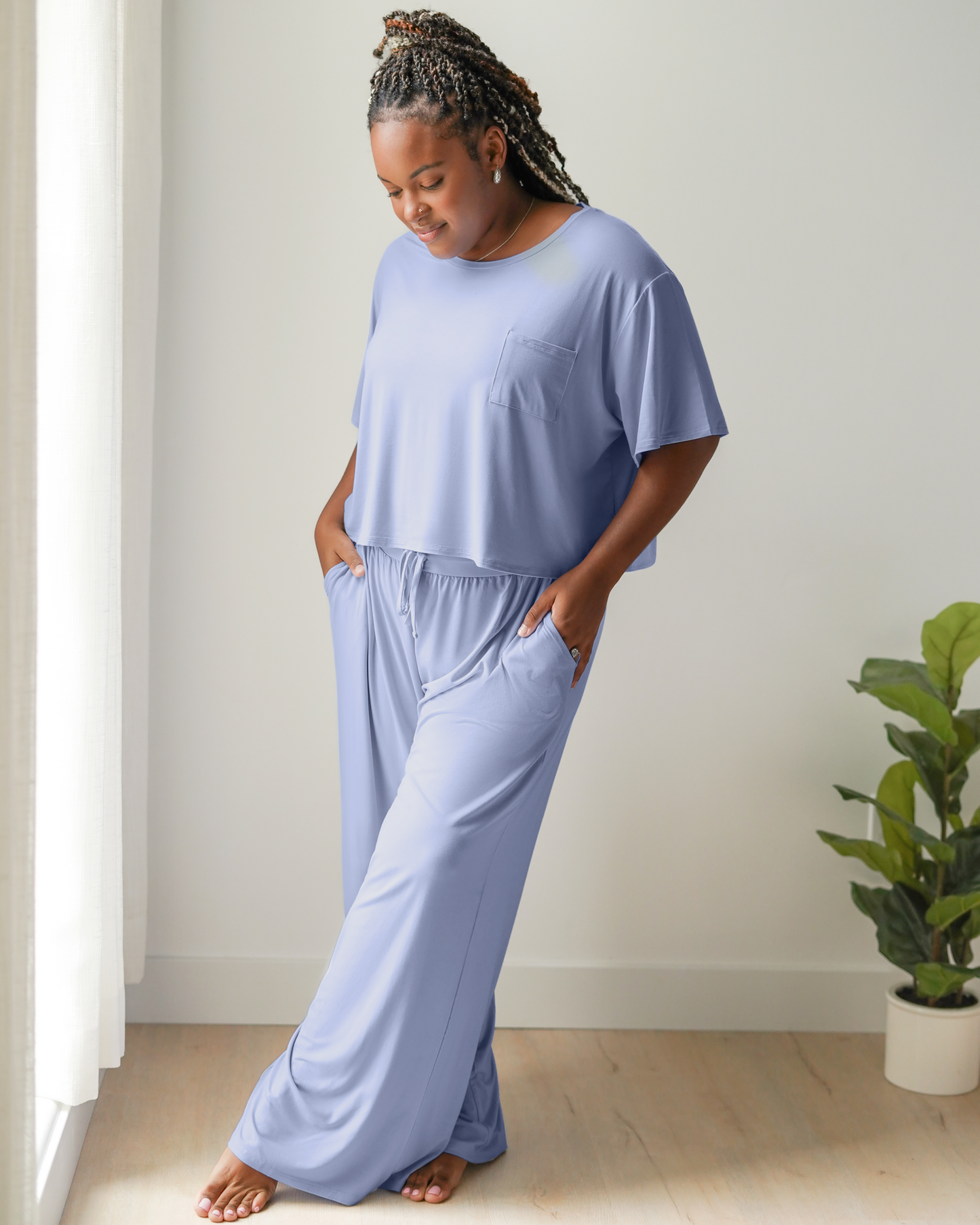 Model wearing the Aria Bamboo Casual Lounge Pant in Periwinkle with hands in pockets, paired with matching Aria Bamboo Casual Cropped Short Sleeve Top @model_info:Tonia is 5'7" and wearing an X-Large.