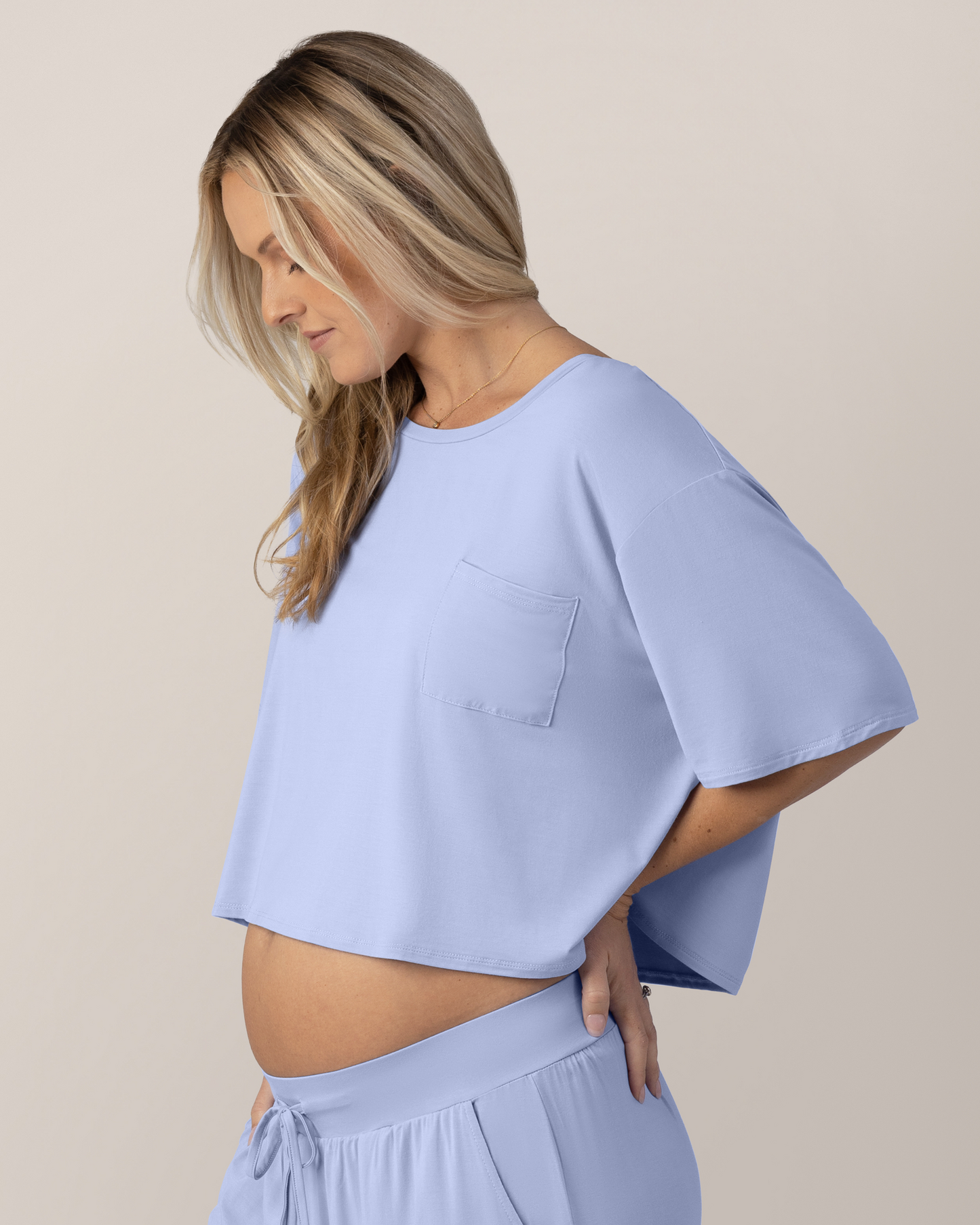 Side view of pregnant model wearing the Aria Bamboo Casual Cropped Short Sleeve Top in Periwinkle