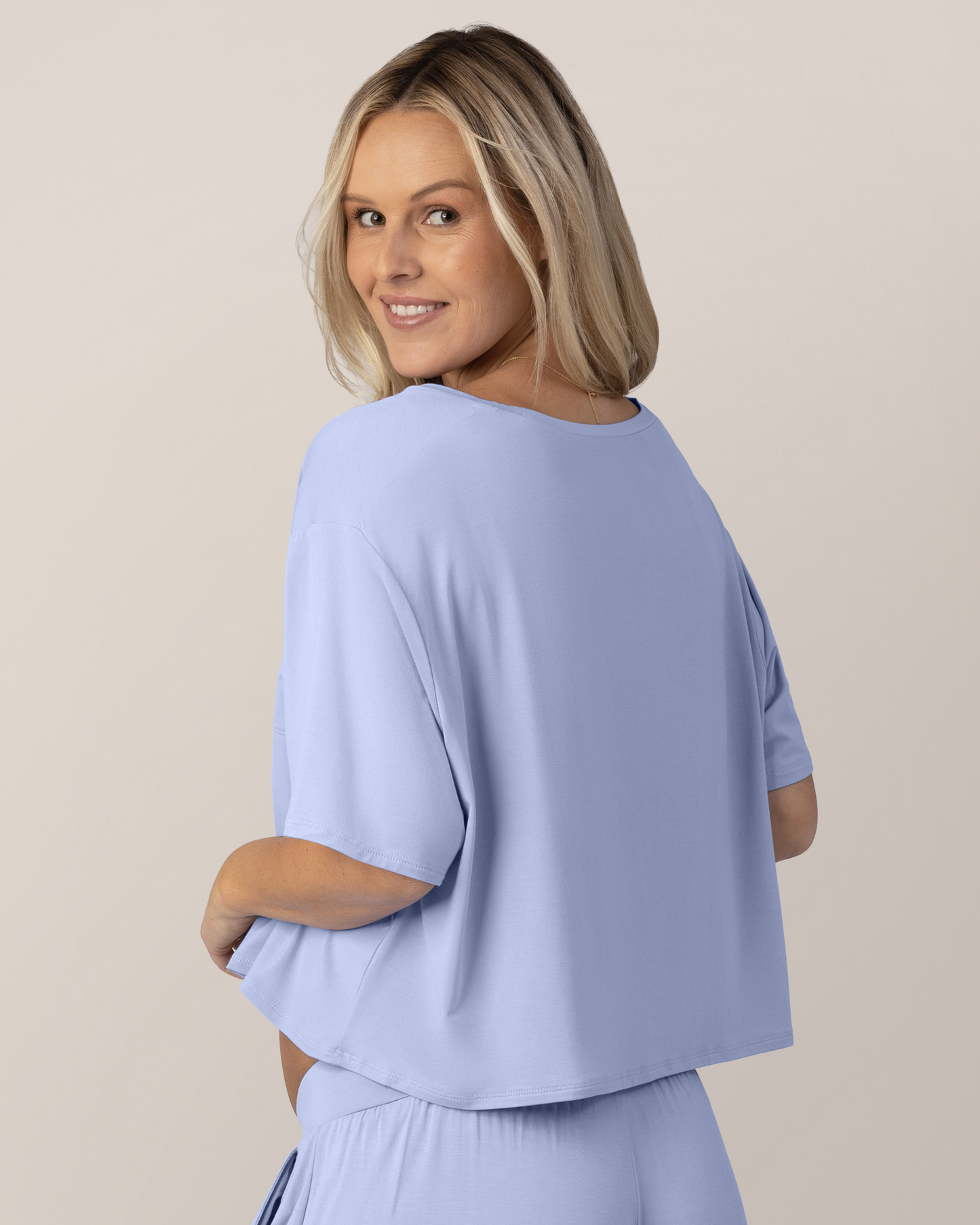 Back view of pregnant model wearing the Aria Bamboo Casual Cropped Short Sleeve Top in Periwinkle