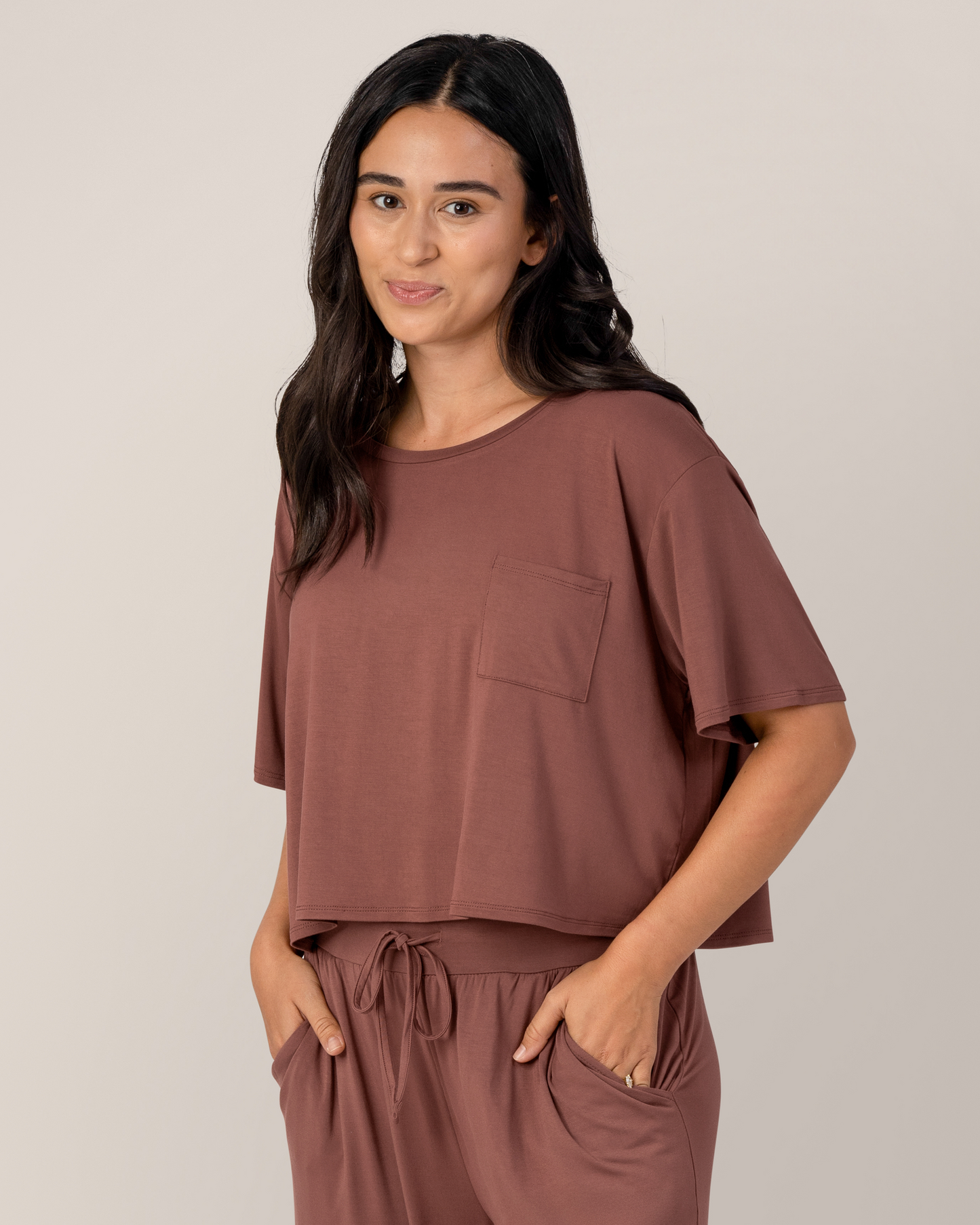 Front view of model wearing the Aria Bamboo Casual Cropped Short Sleeve Top in Redwood @model_info:Anamaria is wearing a Medium.