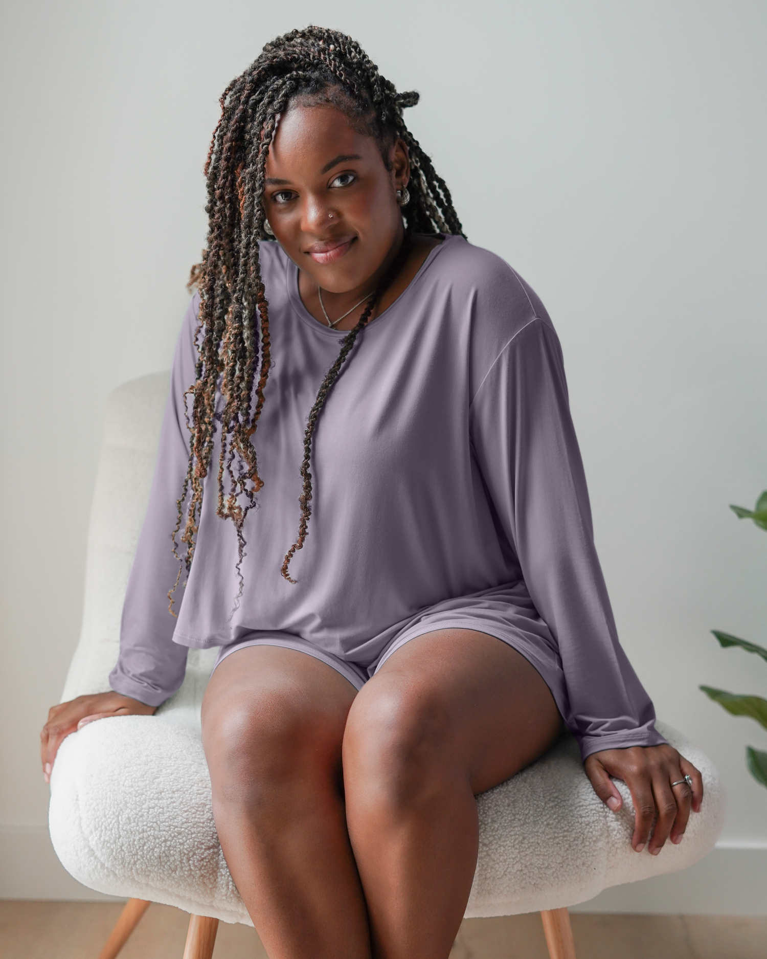 Model sitting while wearing the Aria Bamboo Casual Cropped Long Sleeve Top in Granite paired with the matching Aria Bamboo Casual Lounge Short @model_info:Tonia is wearing a Large.