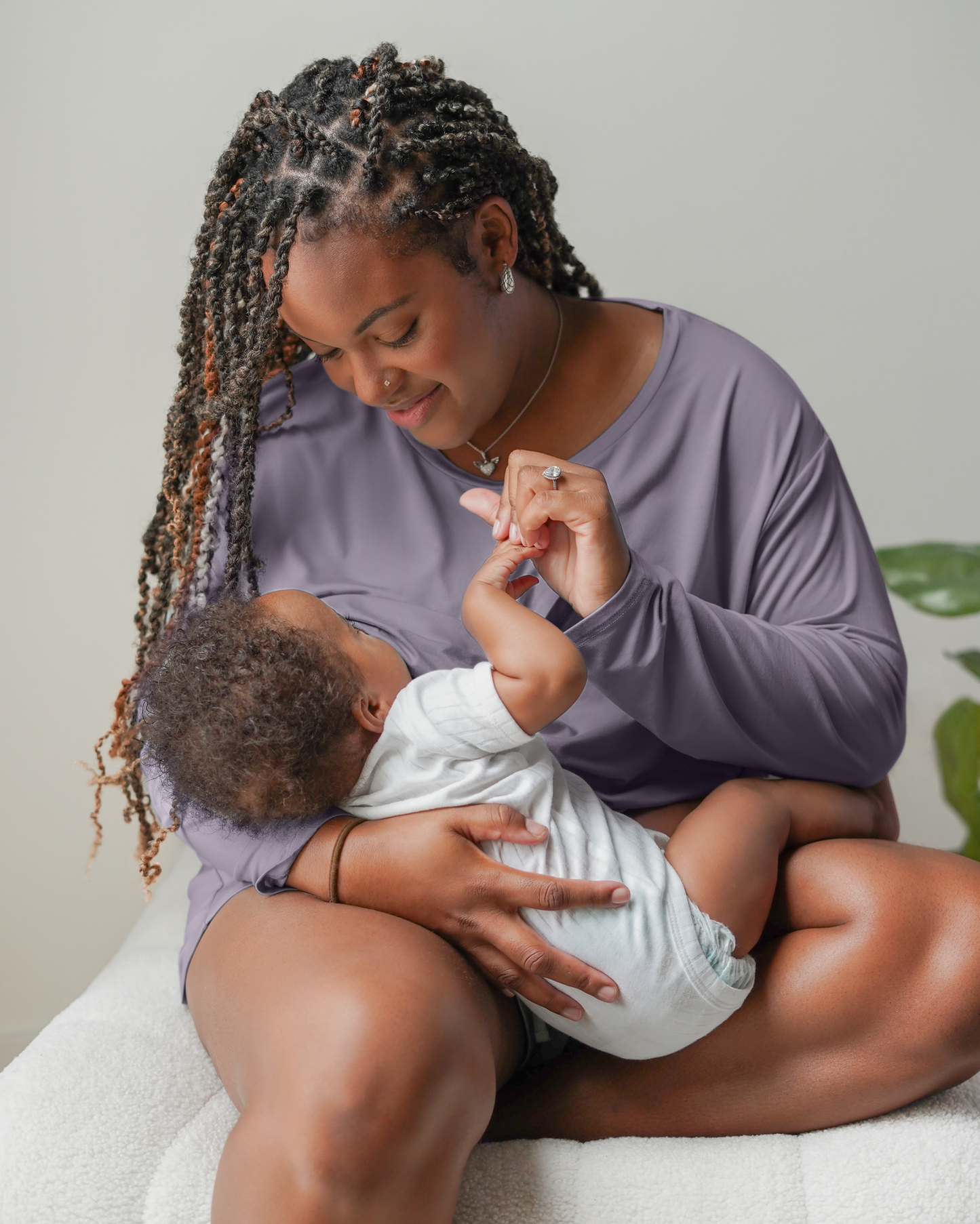 Model nursing baby while wearing the Aria Bamboo Casual Cropped Long Sleeve Top in Granite paired with the matching Aria Bamboo Casual Lounge Short 