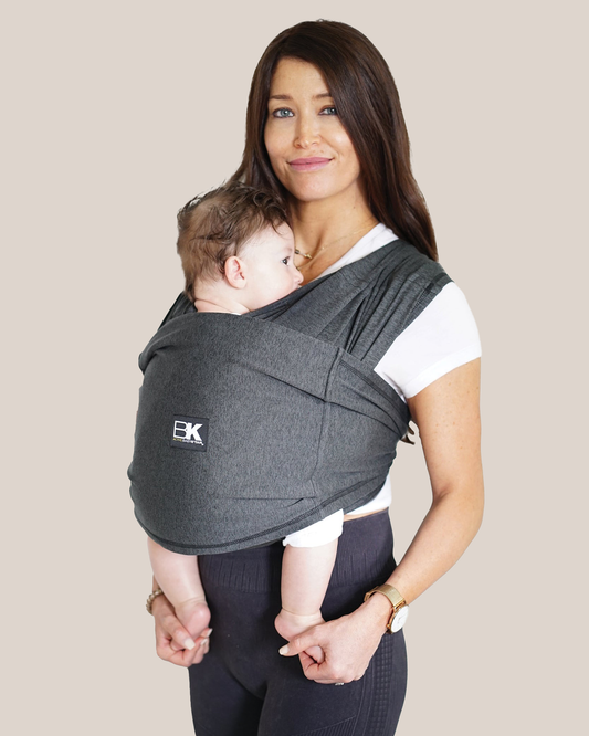 Model wearing baby in the Baby K'tan - Active Yoga Baby Carrier in Heather Black