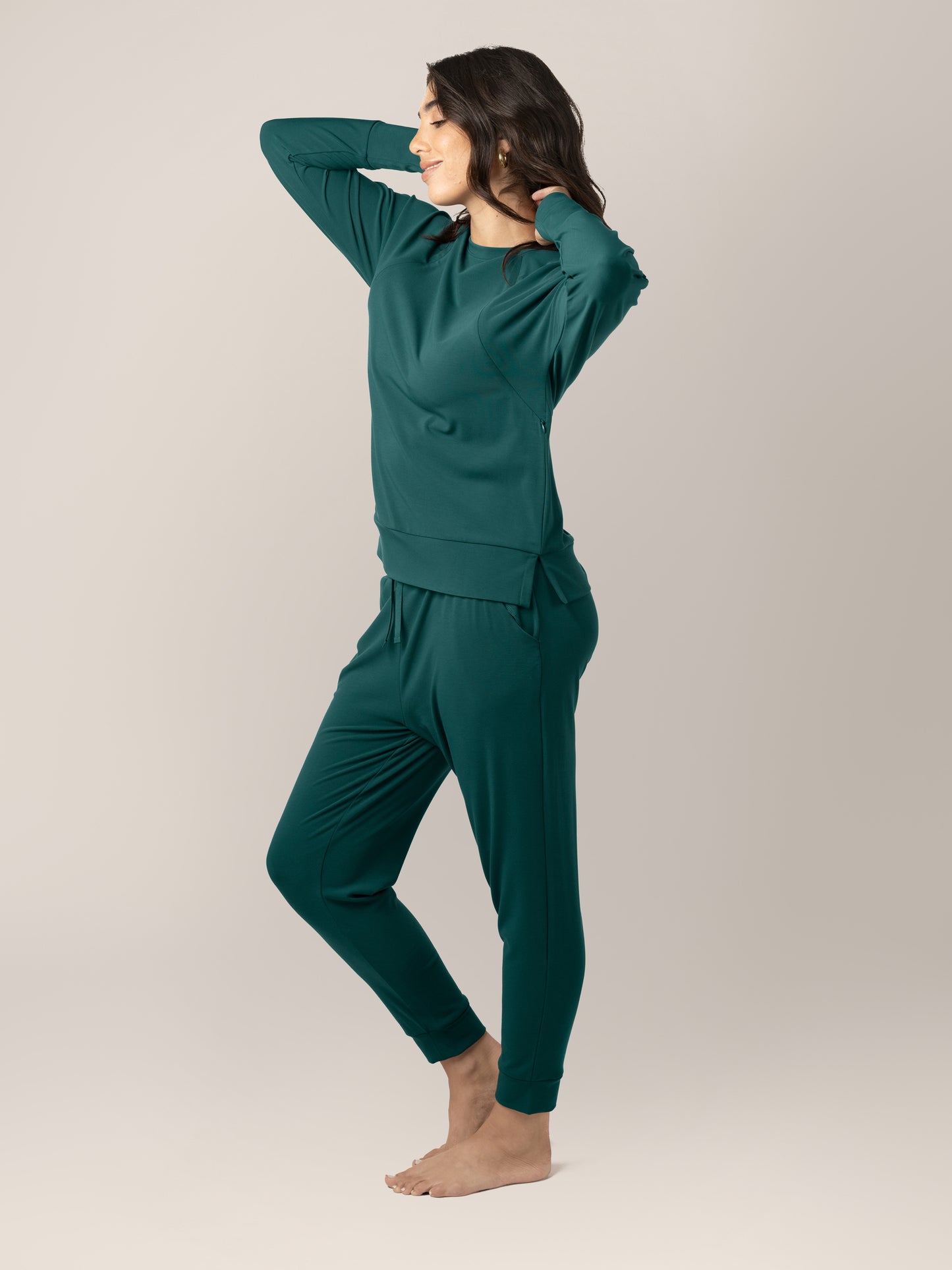 Full body side view of model wearing the Bamboo Maternity & Nursing Crew Neck Sweatshirt in Evergreen, paired with the Everyday Lounge Joggers in Evergreen.