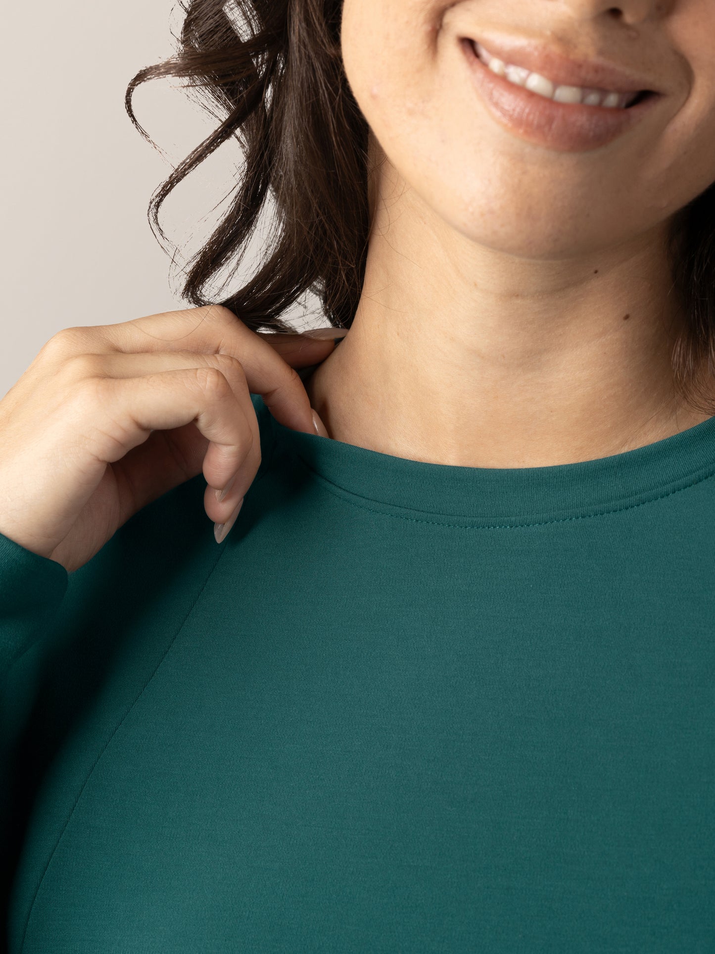 Close up of model wearing the Bamboo Maternity & Nursing Crew Neck Sweatshirt in Evergreen showing crew neck detail..