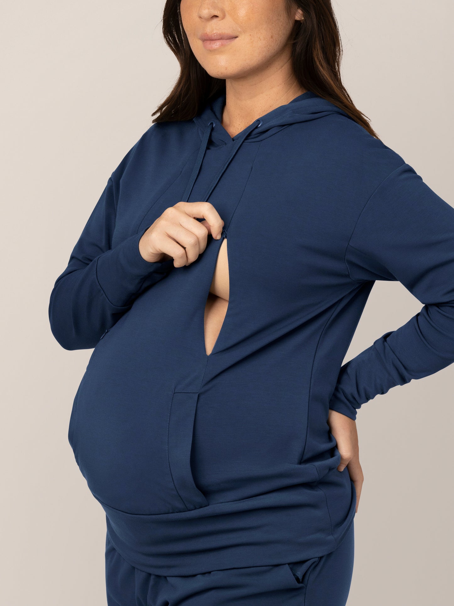 Close up of model wearing the Bamboo Maternity & Nursing Hoodie in Navy, showing zipper nursing access