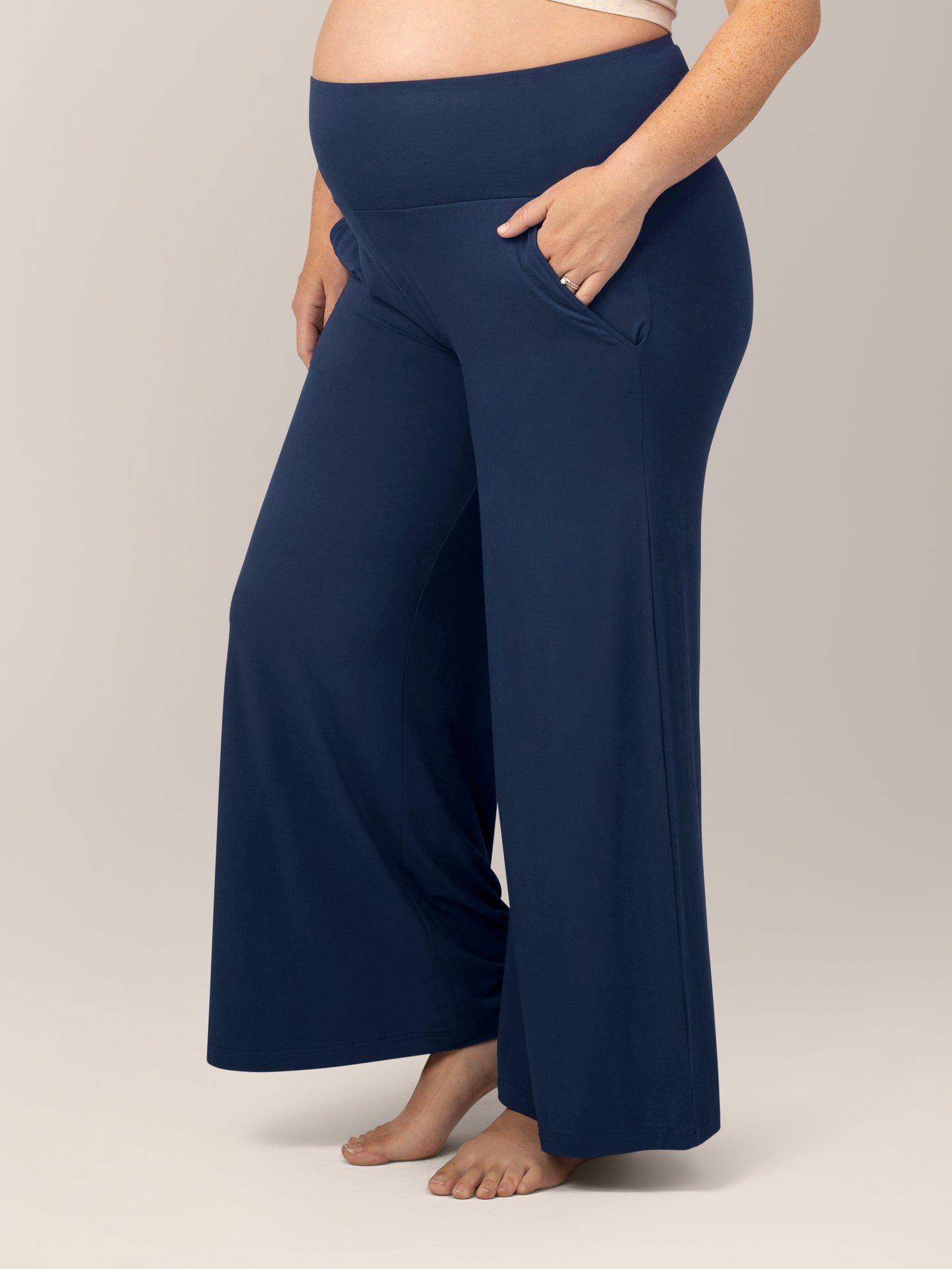 3/4 view of model wearing the Bamboo Wide Leg Maternity & Postpartum Lounge Pant in Navy