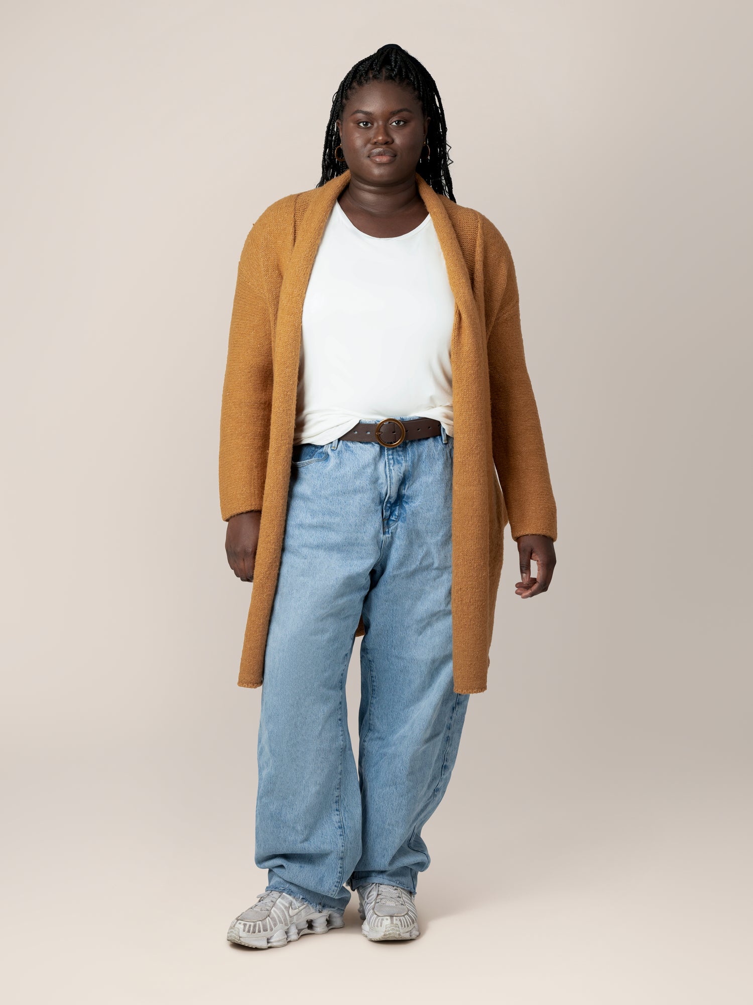 Full body front view of model wearing the Chloe Cardigan Sweater in Chai, paired with a white t-shirt and jeans.