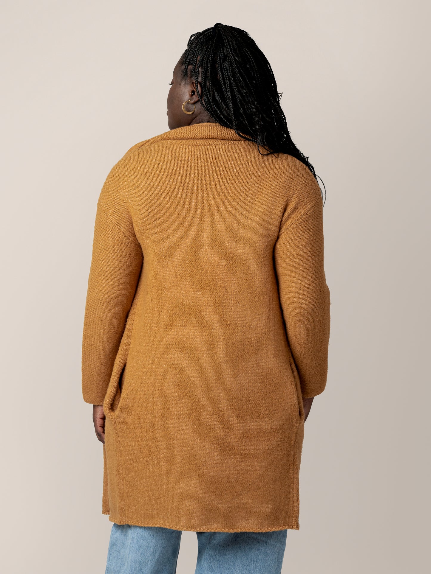 Back view of model wearing the Chloe Cardigan Sweater in Chai.