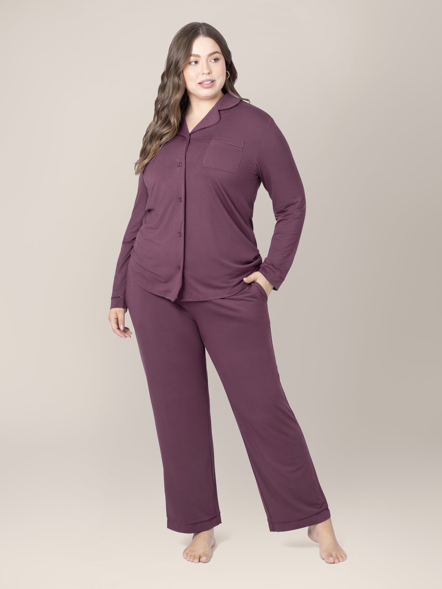 Front view of model wearing the Clea Bamboo Long Sleeve Pajama Set in Burgundy Plum with one hand in pocket @model_info:Bailey is 5'11" and wearing an X-Large.