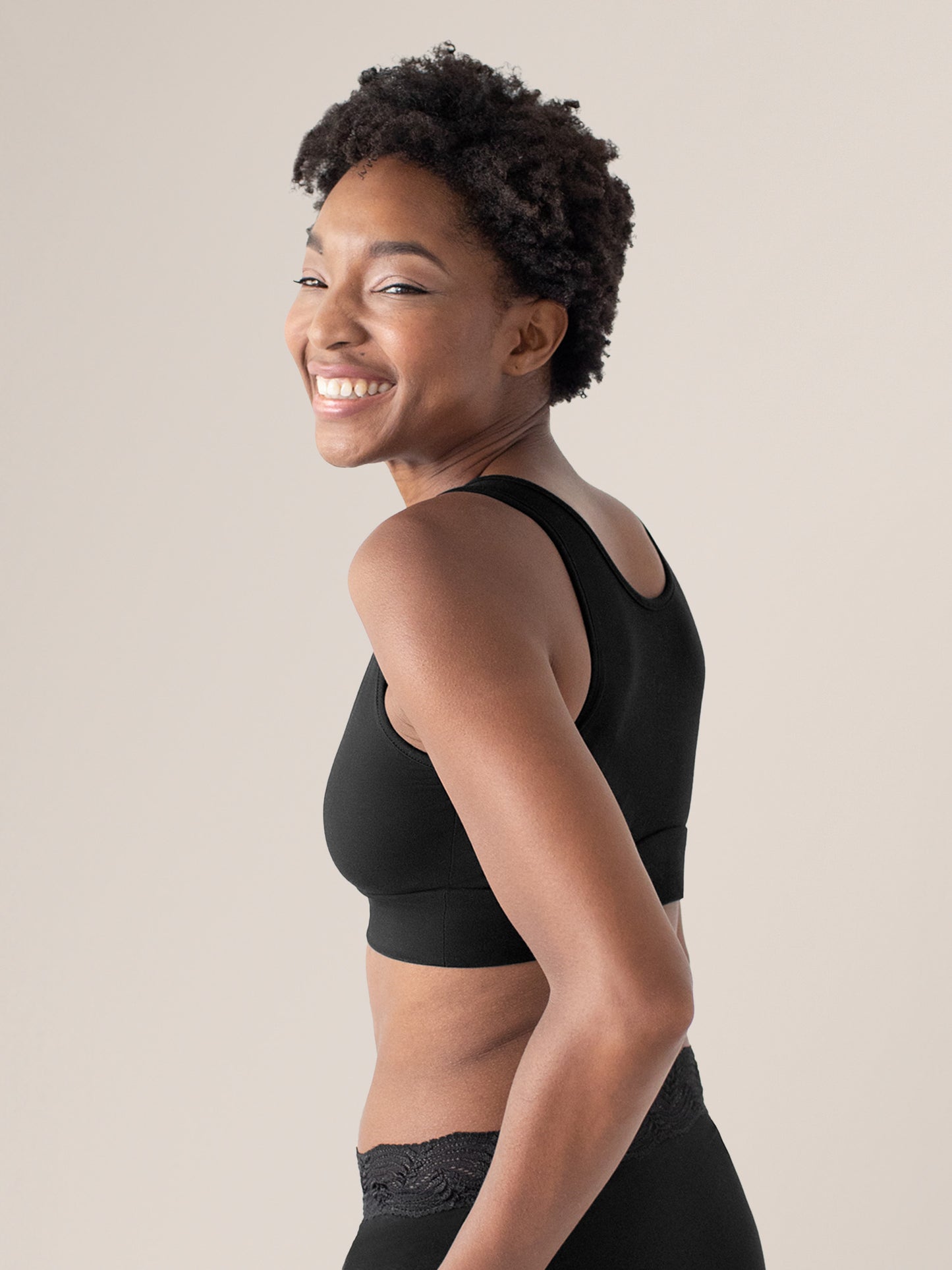 Side view of model wearing the Model wearing the Organic Cotton Sleep & Nursing Bra in Black