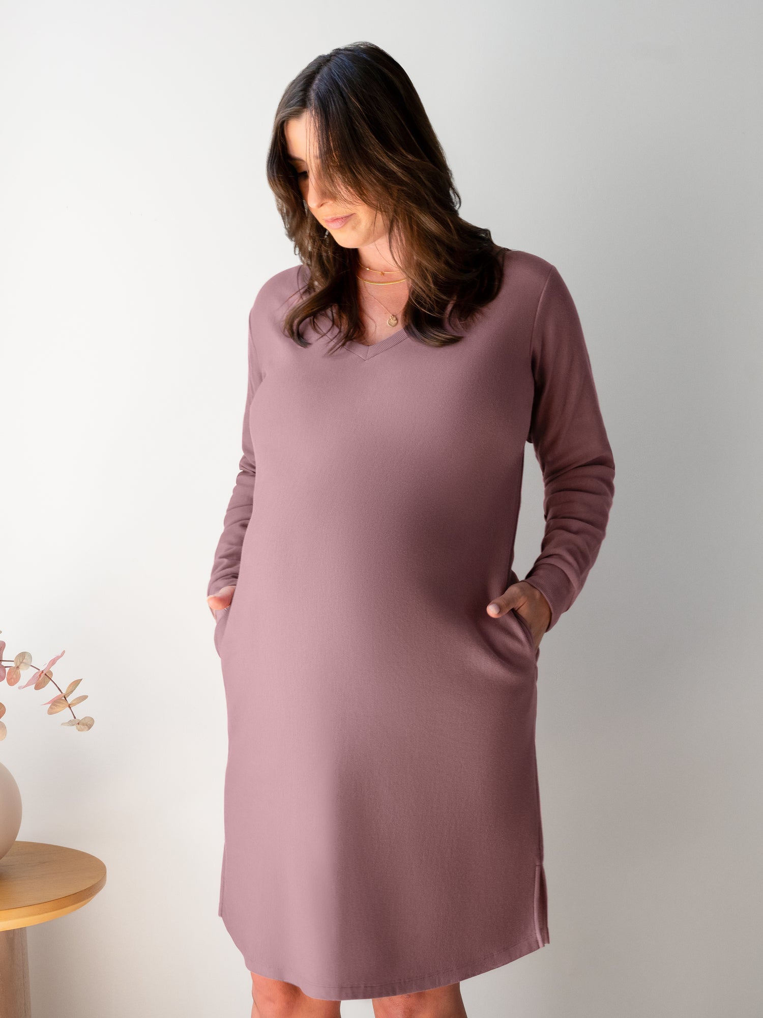 Front view of pregnant model wearing the Blake Oversized Maternity & Nursing Lounge Dress in Twilight, with hands in pockets.
 @model_info:Kiersten is 5'9" and  wearing a Large.