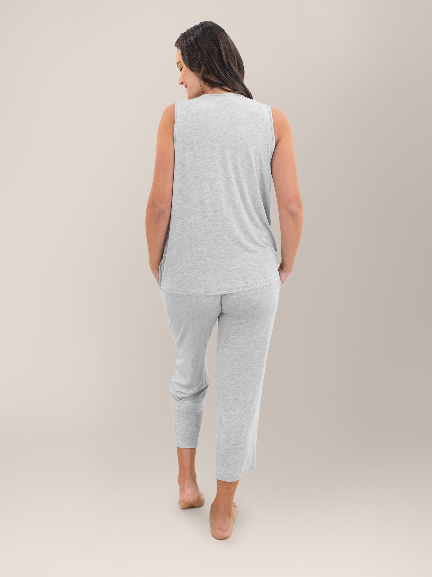 Full body back view of model wearing the Tulip Hem Nursing Tank & Capri Pajama Set in Grey Heather.