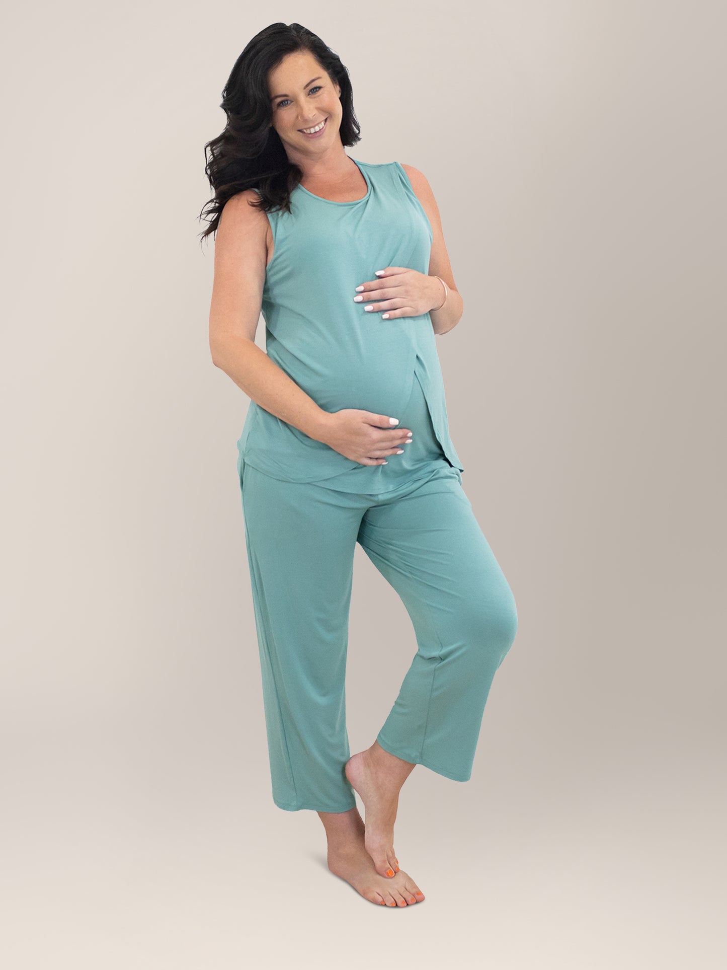 3/4 full body view of pregnant model wearing the Tulip Hem Nursing Tank & Capri Pajama Set in Aqua.