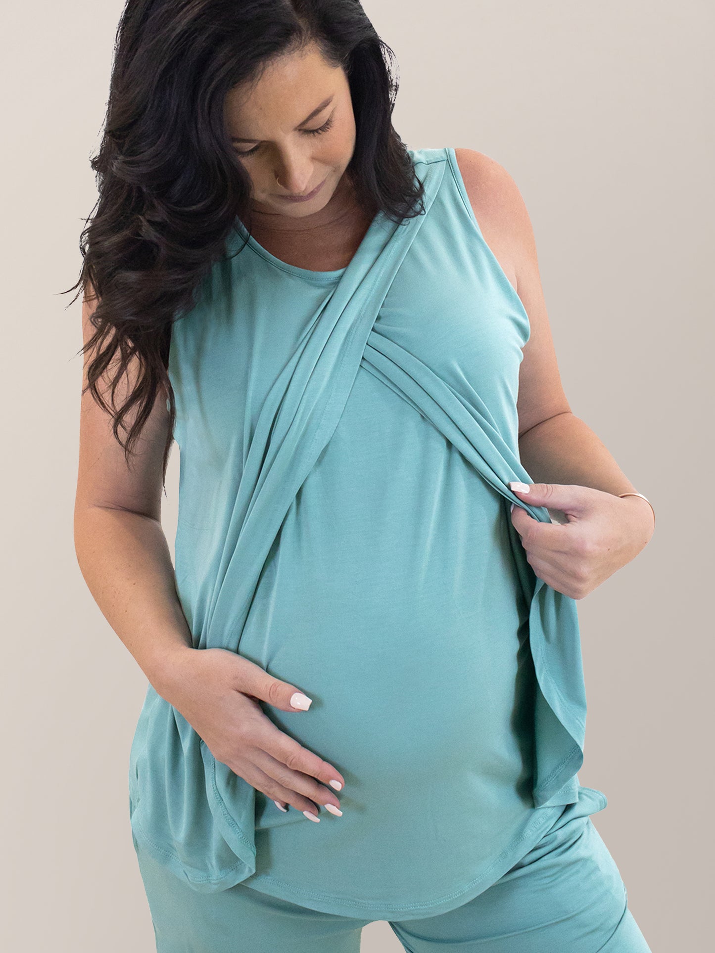Cropped in view of pregnant model wearing the Tulip Hem Nursing Tank & Capri Pajama Set in Aqua, showing crossover layers and nursing access.