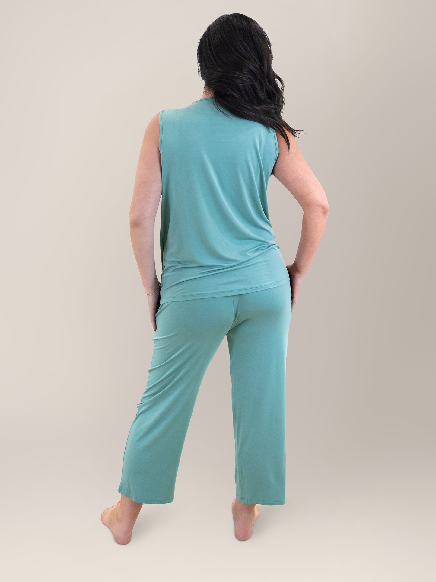 Back full body view of pregnant model wearing the Tulip Hem Nursing Tank & Capri Pajama Set in Aqua.