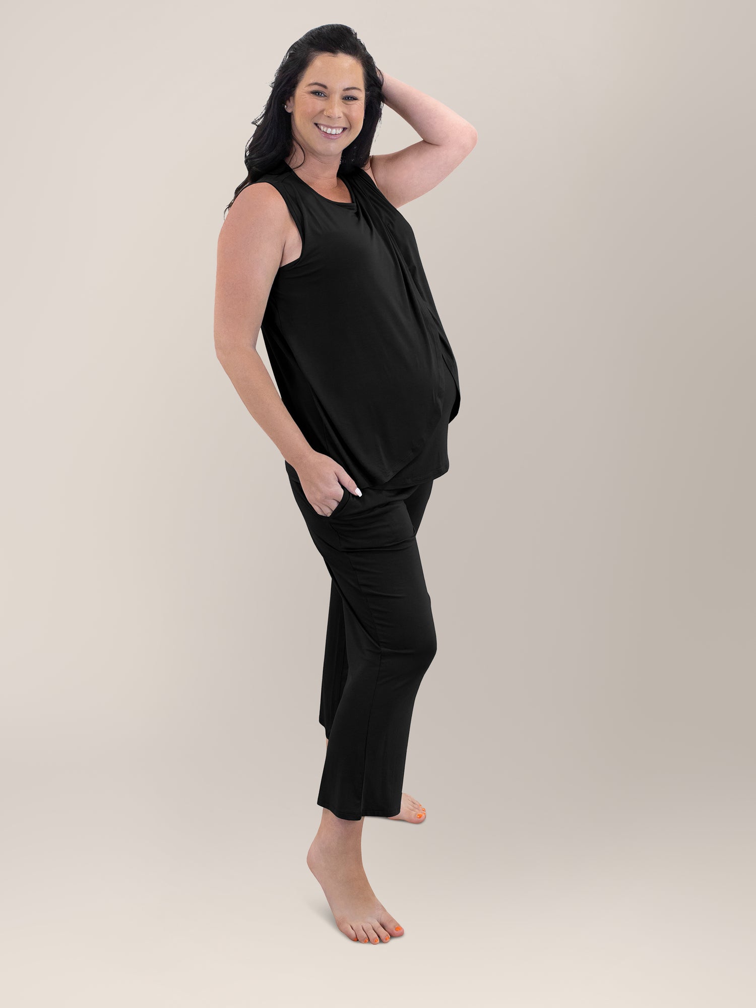 Side view of pregnant model wearing the Tulip Hem Nursing Tank & Capri Pajama Set in Black