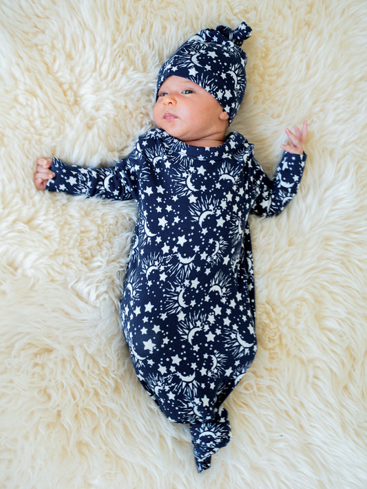 Newborn wearing the Baby Knotted Gown & Hat Set in Navy Stars.