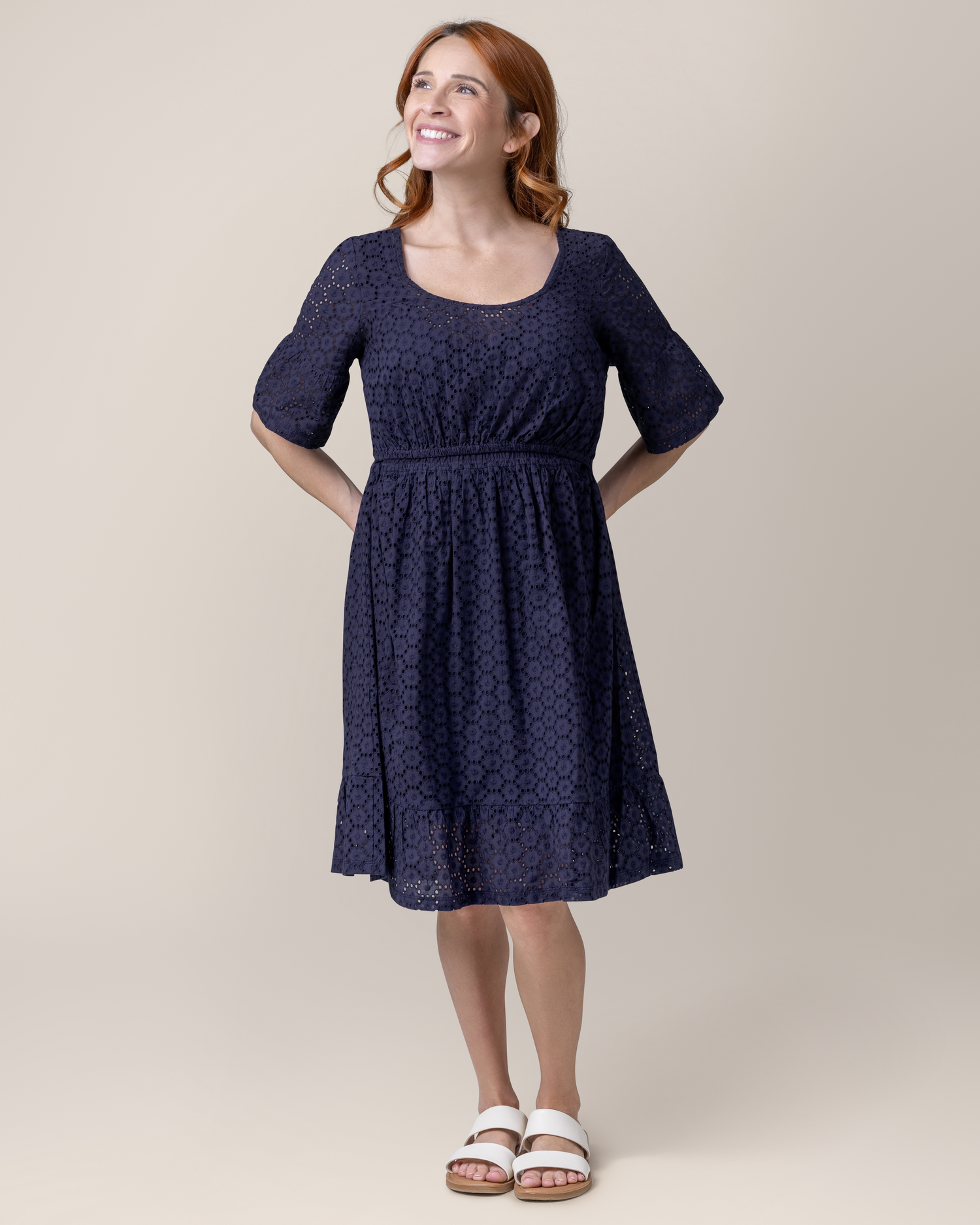 Front view of model wearing the Dahlia Eyelet Maternity & Nursing Dress in Navy