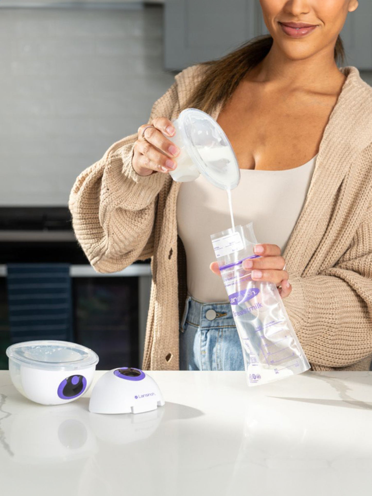 Model pouring milk from Lansinoh Discreet Duo™ Wearable Pump into breastmilk storage bag.