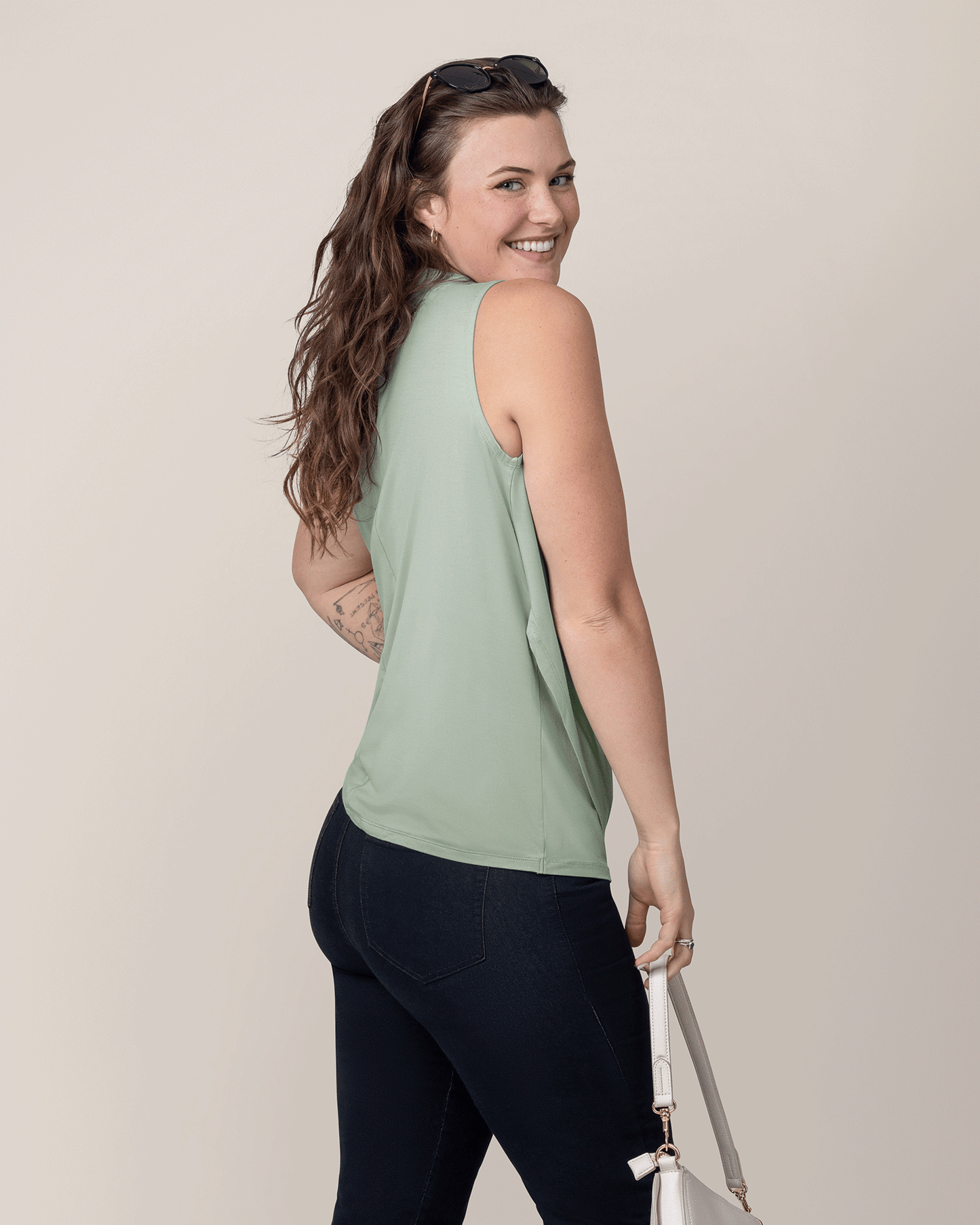 Side back view of model wearing the Bamboo Draped Nursing Tank in Aqua Mist 