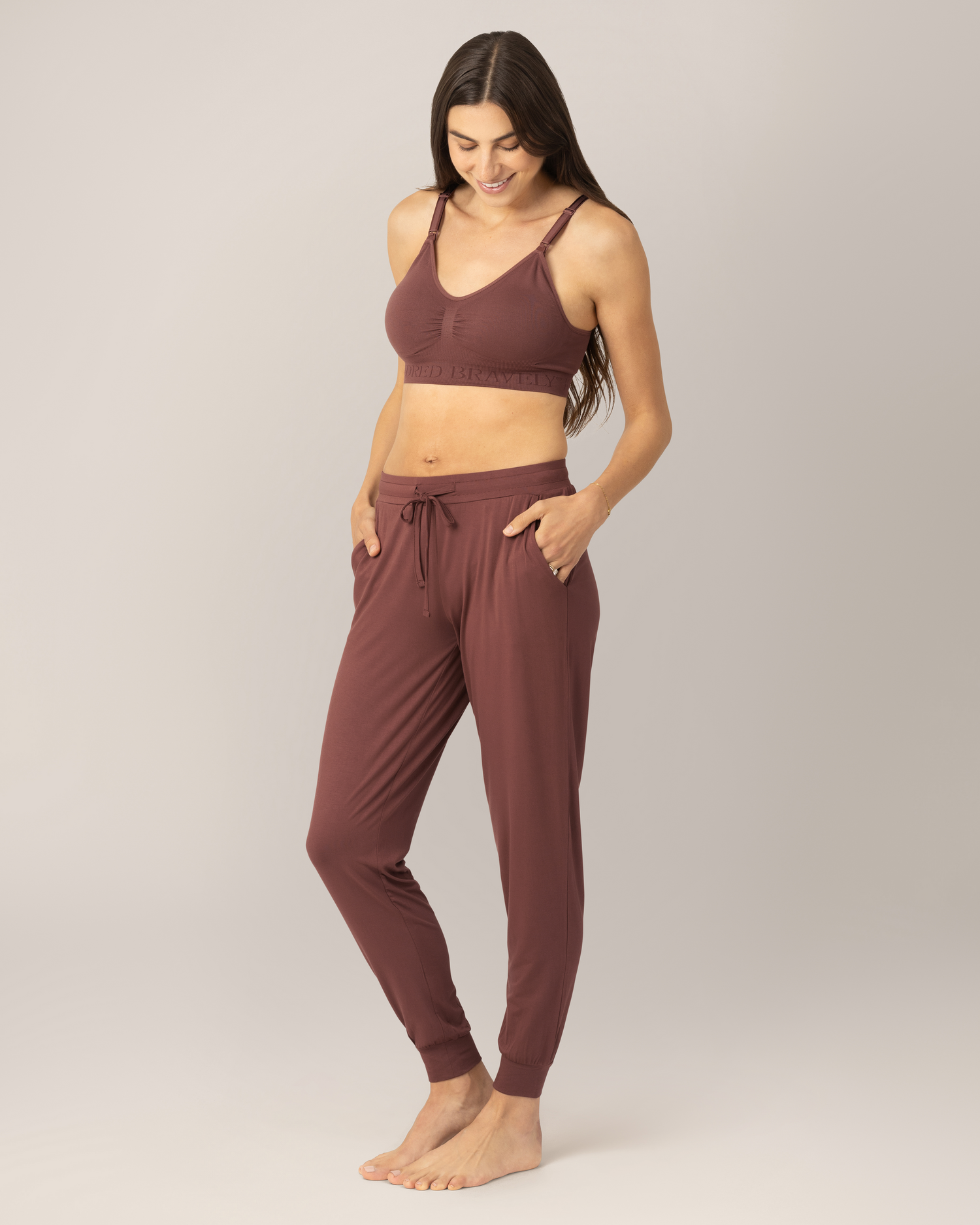 3/4 front view of model wearing the Everyday Lounger Jogger in Redwood, with hands in pockets.