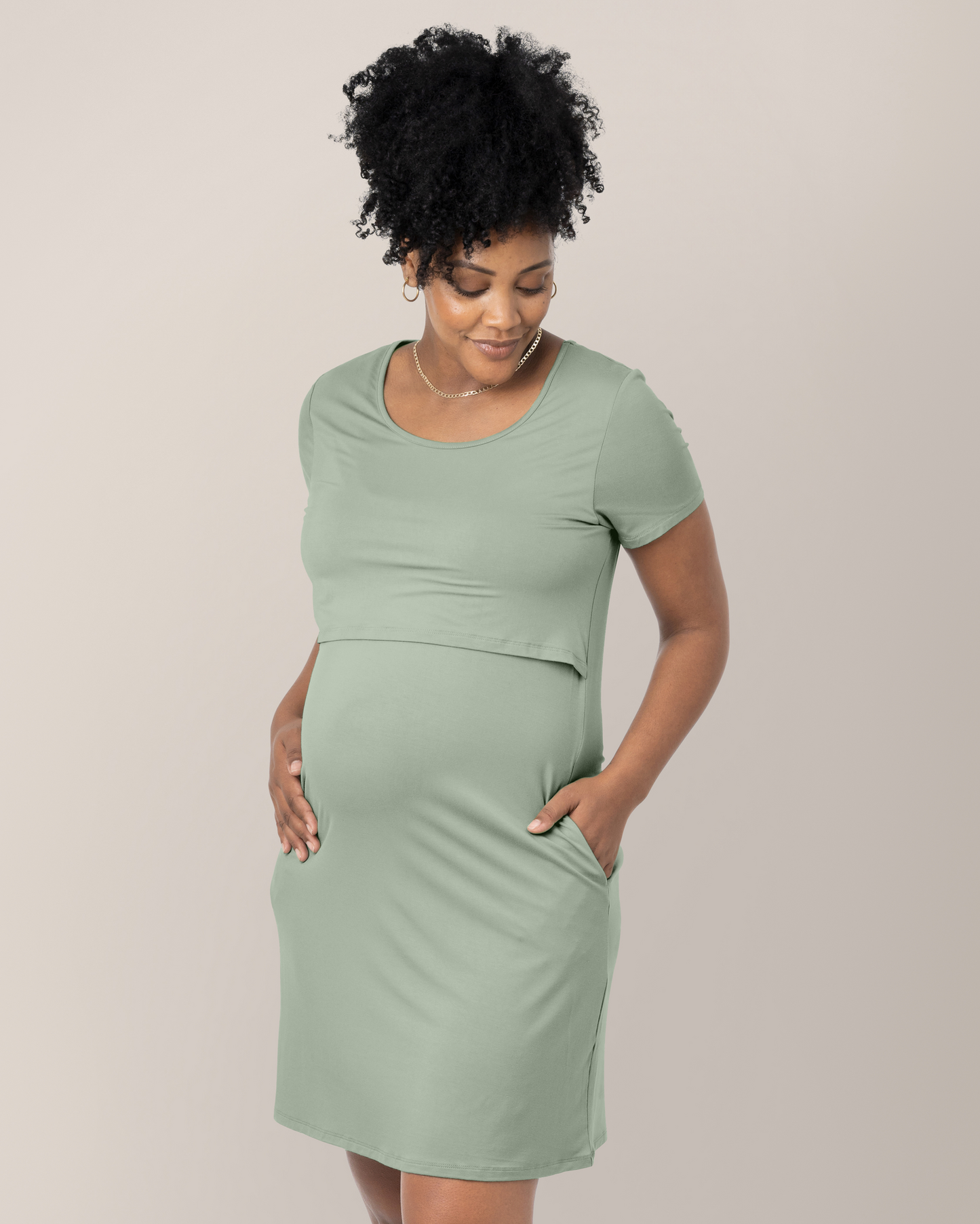 Cropped in front view of model wearing the Eleanora Bamboo Maternity & Nursing Dress in Aqua Mist, with hand in pocket 