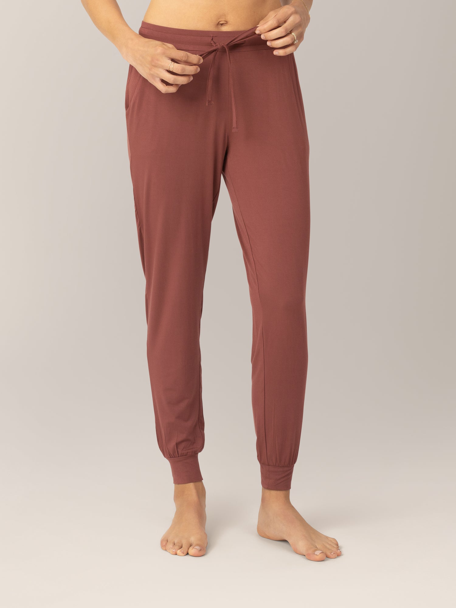 Close up front view of model wearing the Everyday Lounger Jogger in Redwood, showing the drawstring