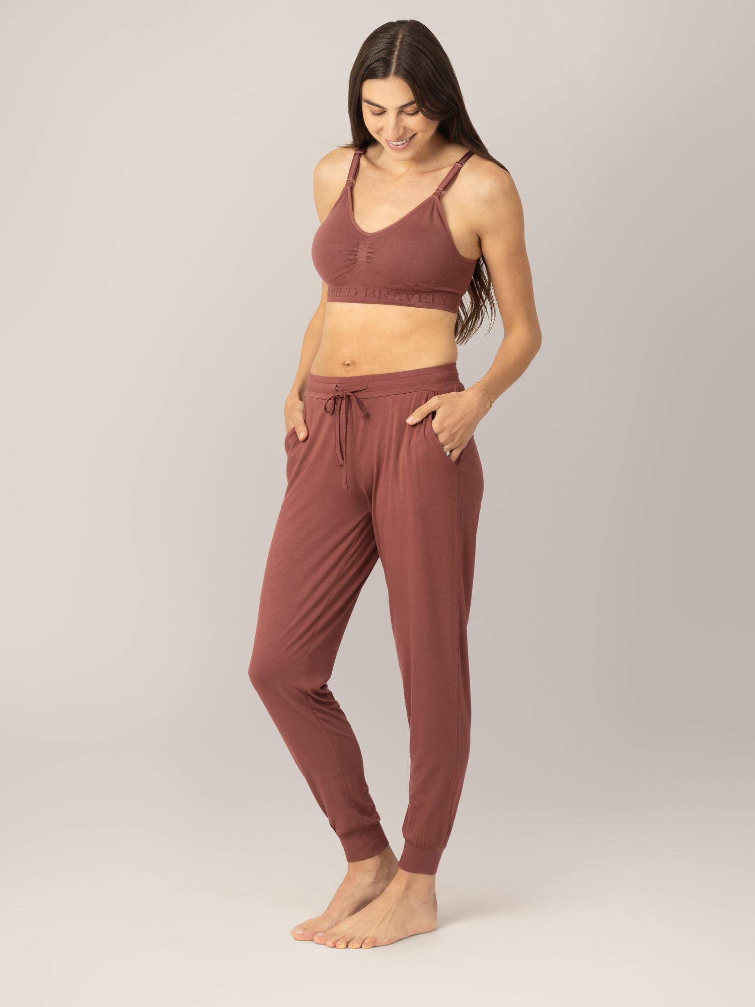 3/4 front view of model wearing the Everyday Lounger Jogger in Redwood, with hands in pockets.