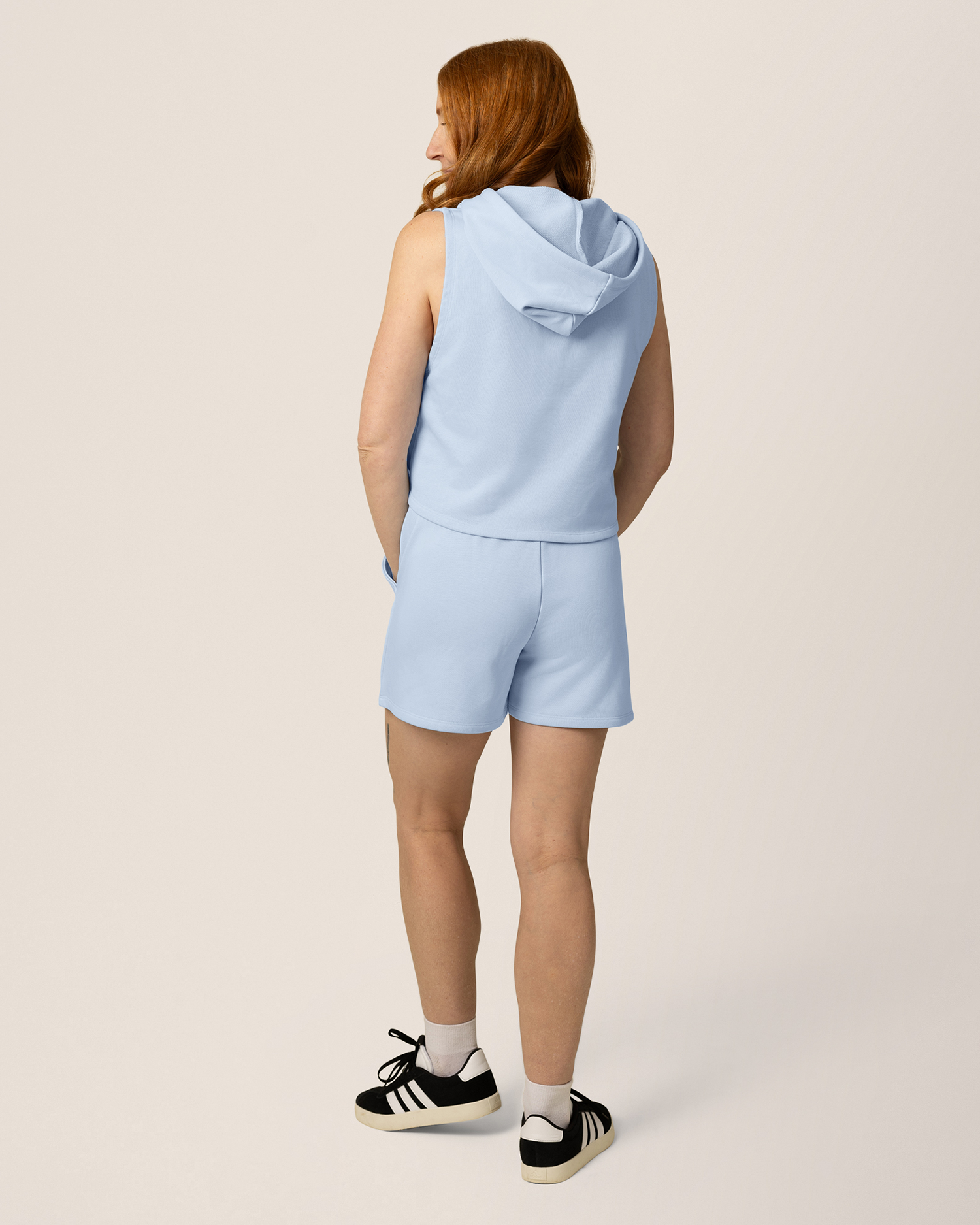 Back view of model wearing French Terry Sleeveless Nursing Hoodie in French Blue with matching French Terry On the Go Short 