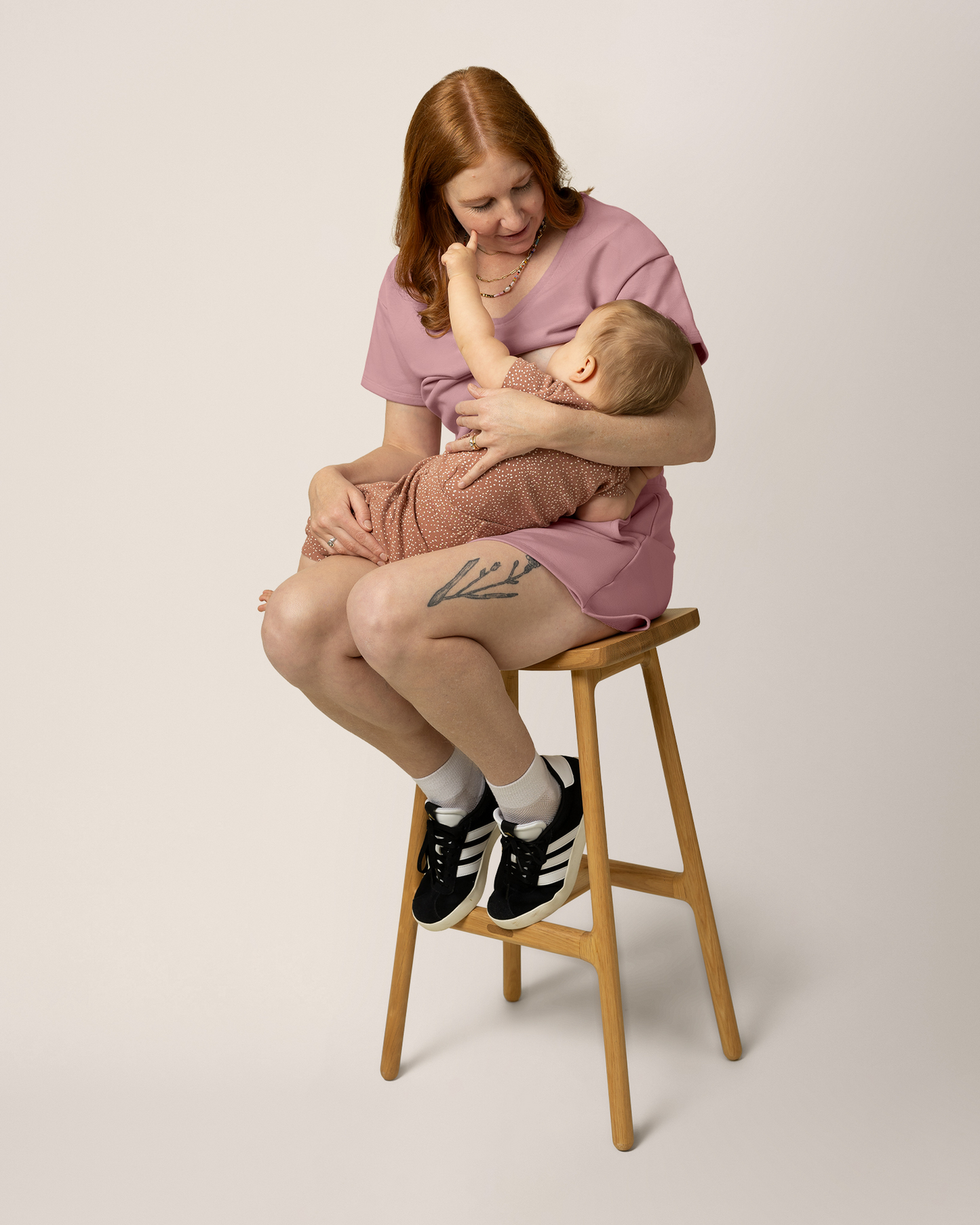 Model wearing French Terry Nursing T-shirt in Light Mauve with matching French Terry On the Go Skort, holding baby