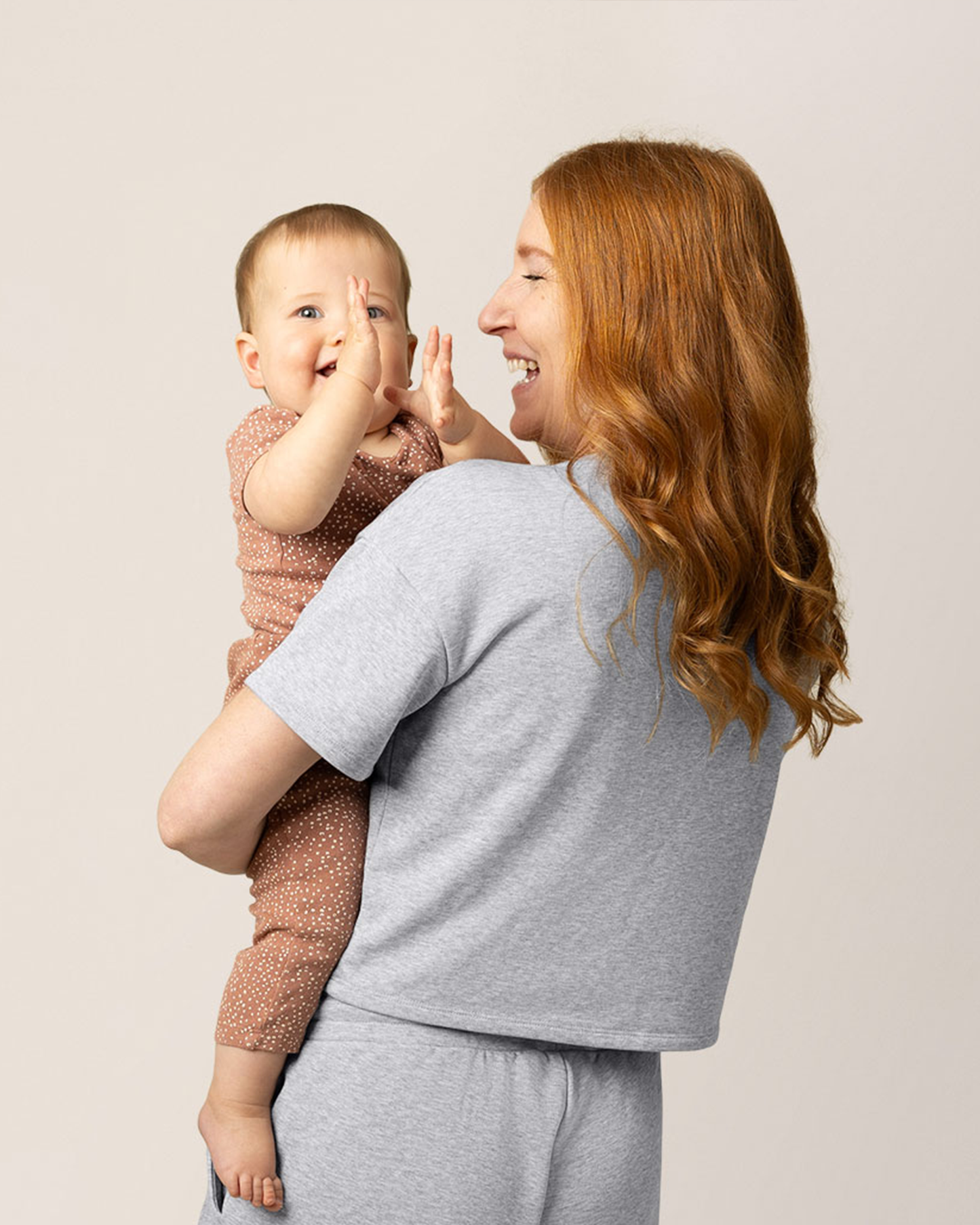 Back view of model wearing French Terry Nursing T-shirt in Grey Heather with matching French Terry On the Go Short , holding baby