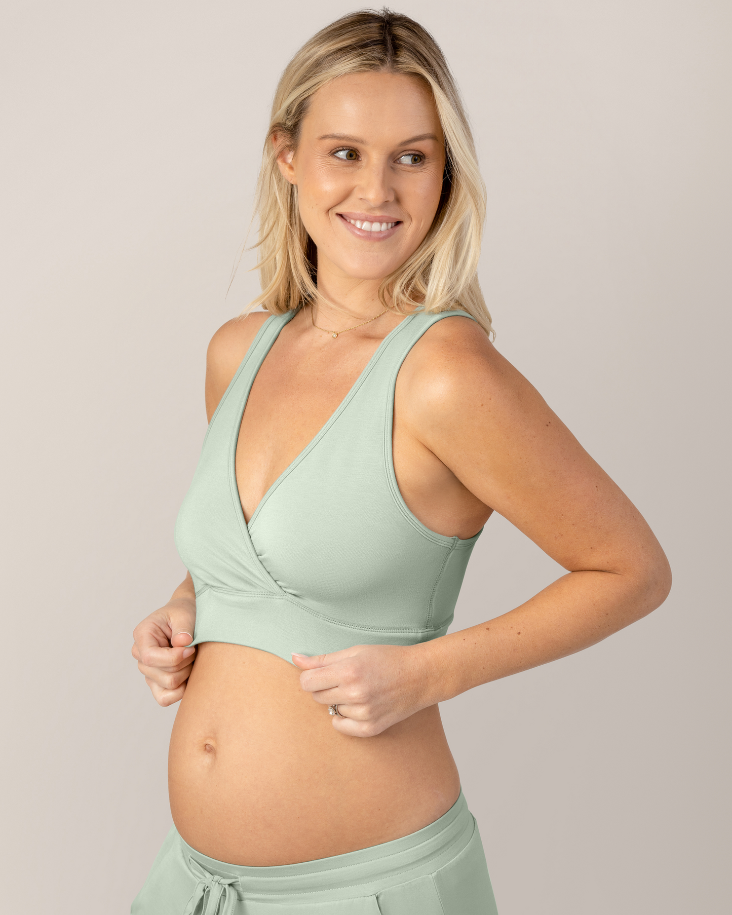 3/4 view of model wearing the French Terry Racerback Nursing & Sleep Bra in Aqua Mist