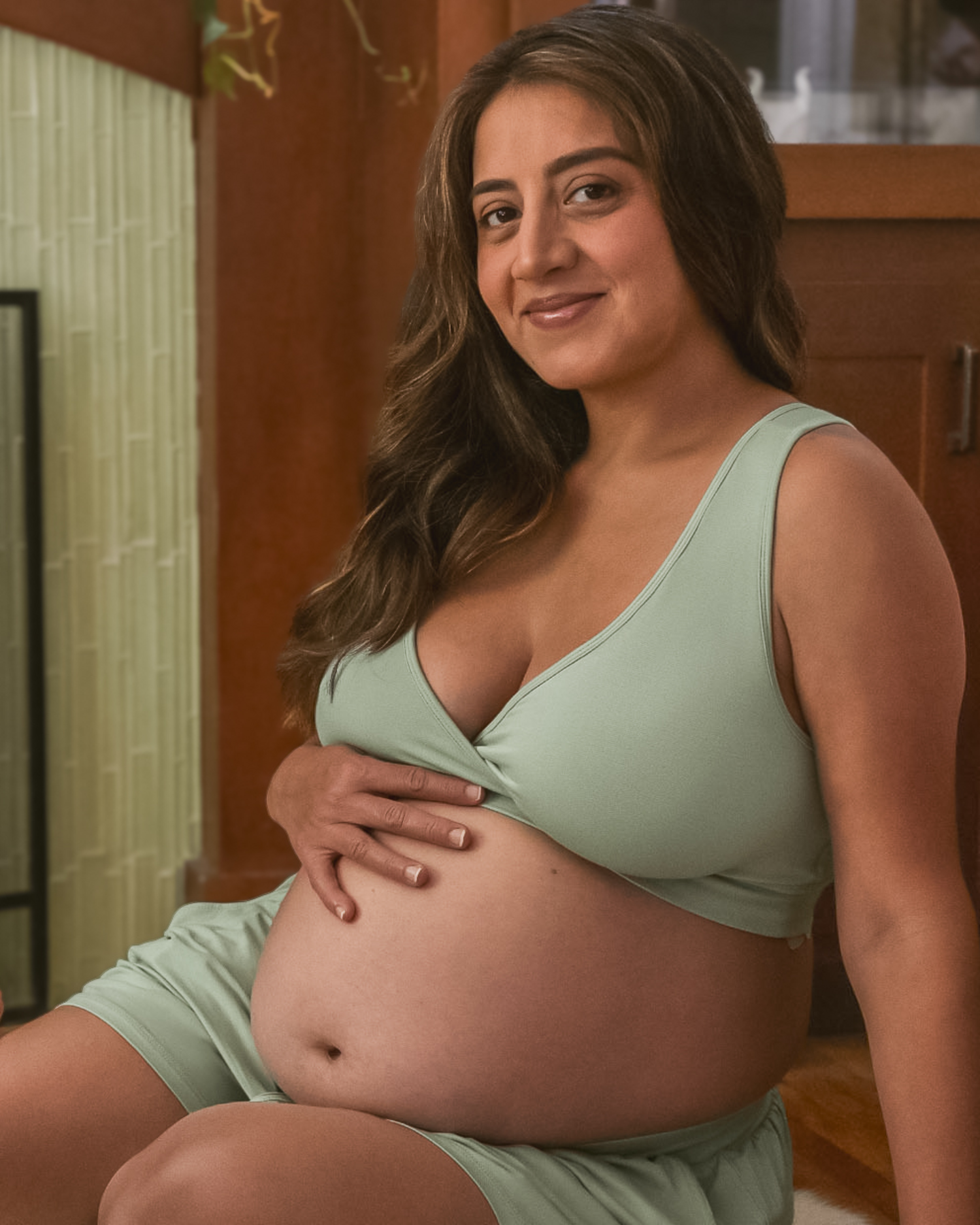 Pregnant model wearing the French Terry Racerback Nursing & Sleep Bra in Aqua Mist, with hand on belly
@model_info:Jaqueline is wearing a Large.