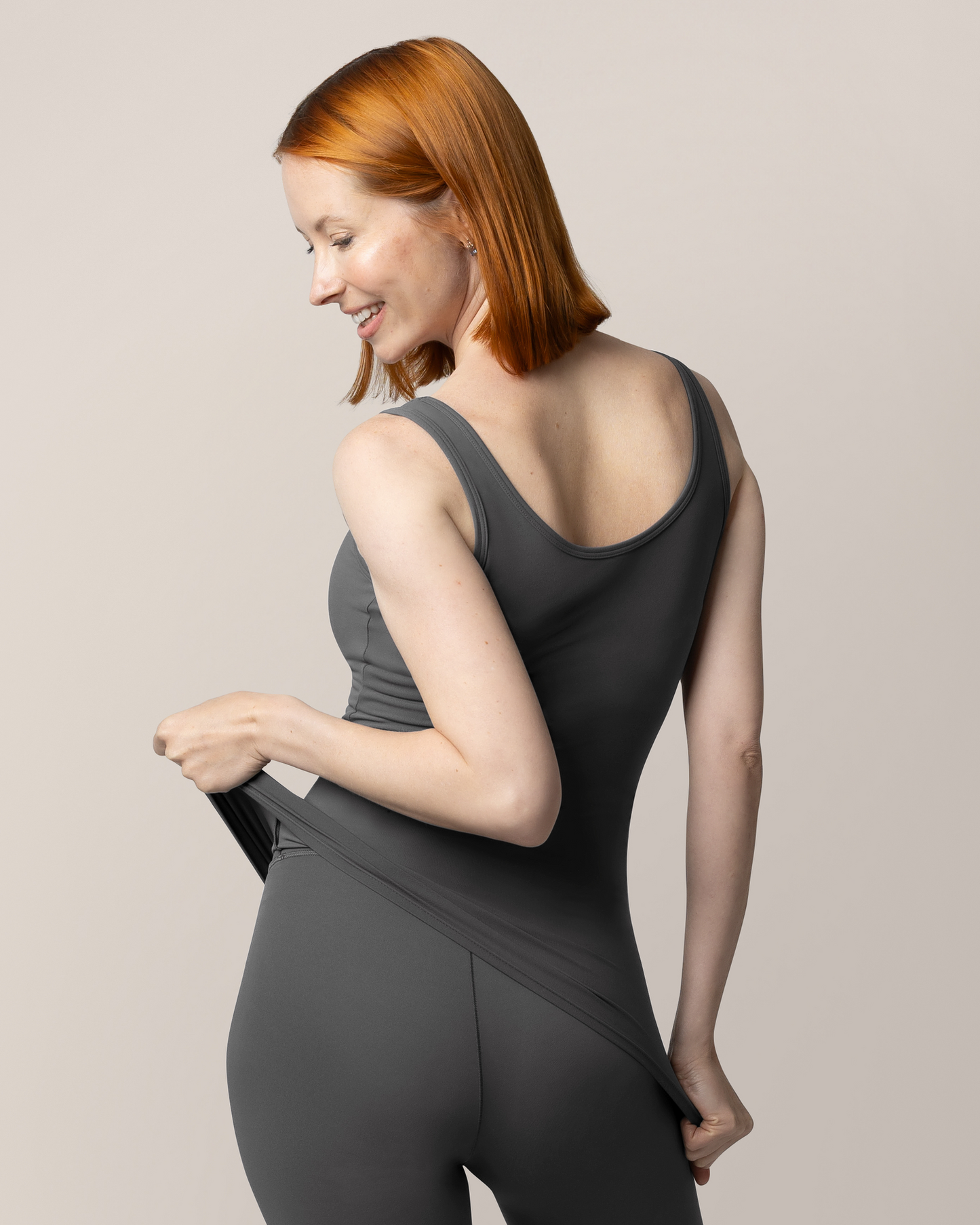 3/4 back view of model wearing the Grow with Me™ Maternity & Nursing Tank in Stormy Grey